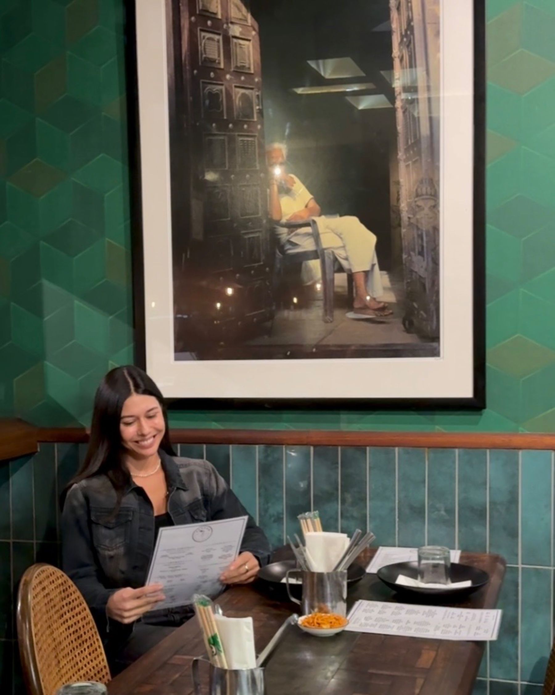Paige is reading the menu at Sundoo Sea Point