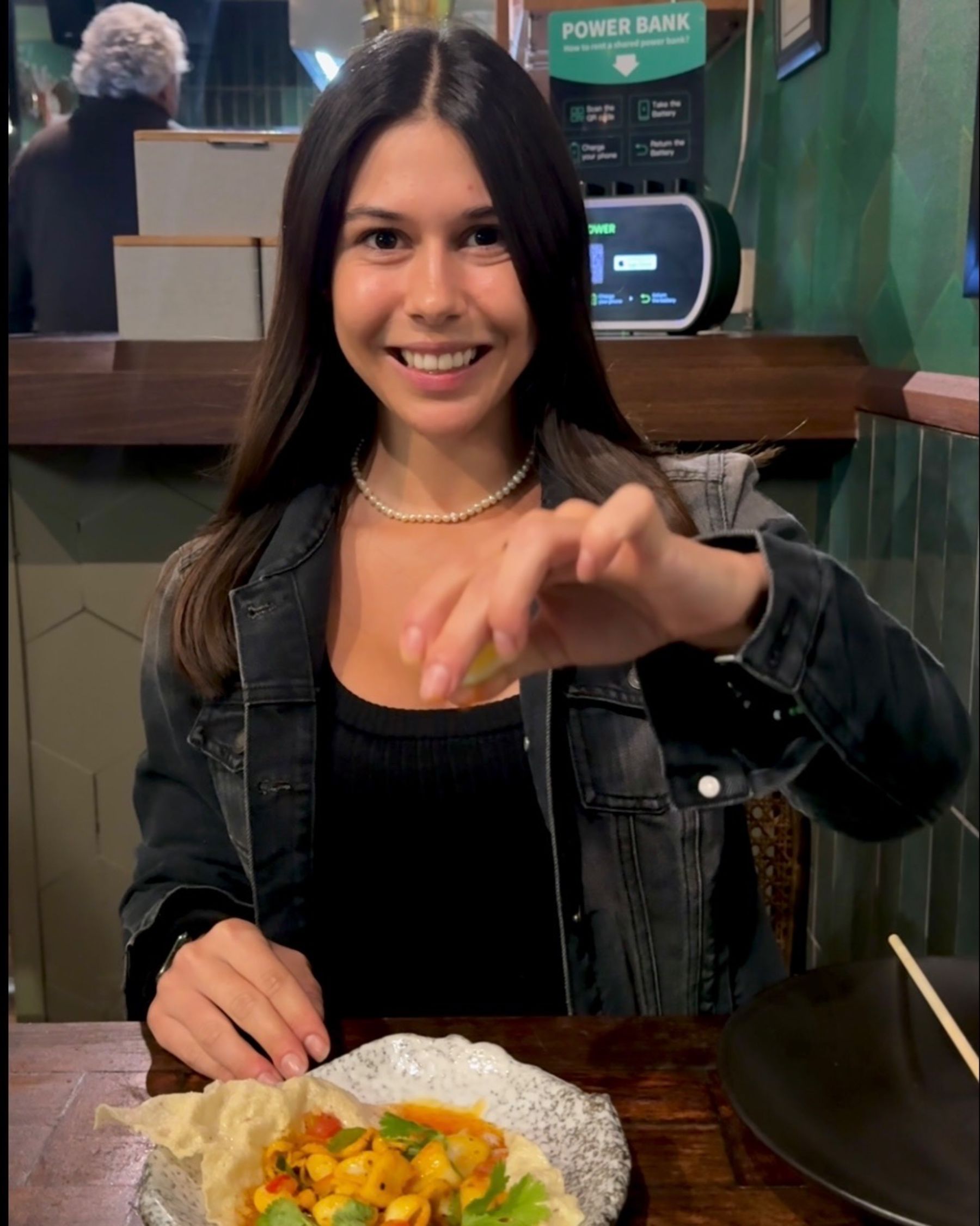 Paige is eating wok-fried calamari at Sundoo Sea Point