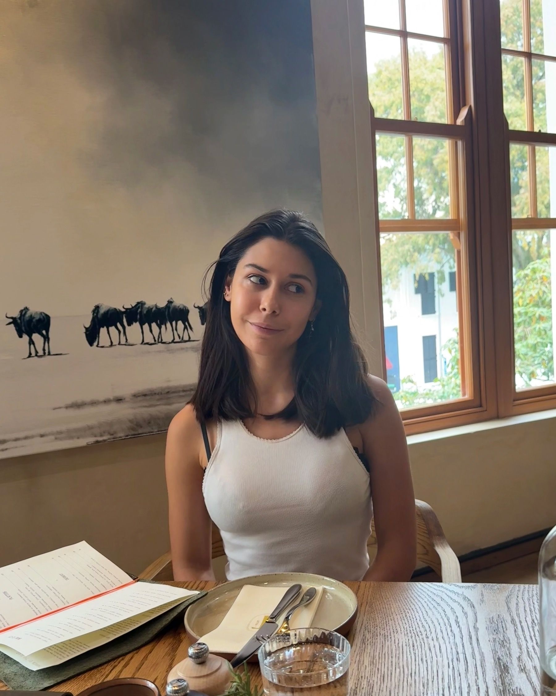 Paige smiling at table inside Tannin on Bree restaurant on Bree Street
