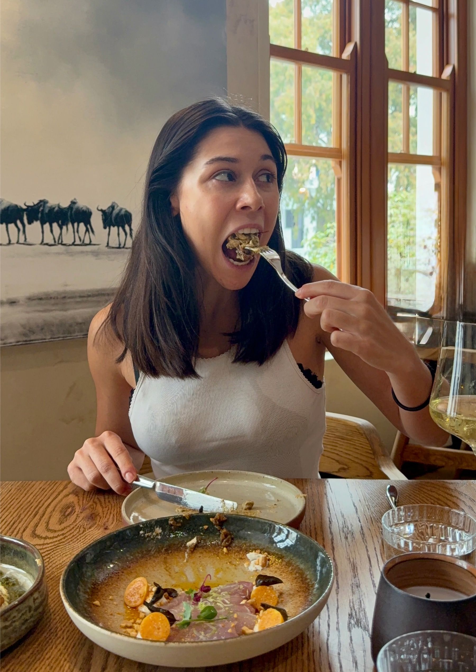 Paige eating tandoori cauliflower with hummus at Tannin on Bree Cape Town