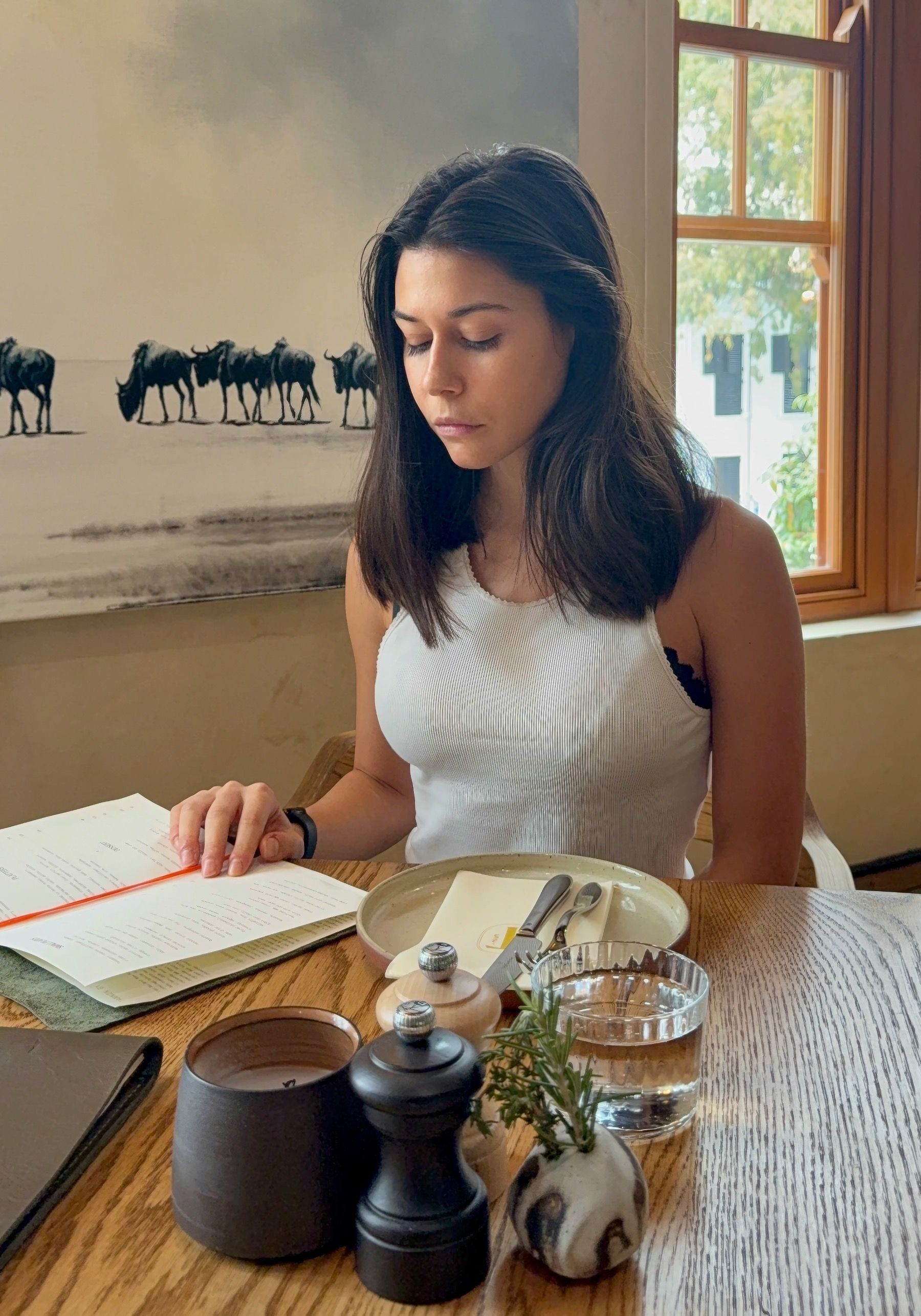 Paige reading the wine and small plates menu at Tannin on Bree