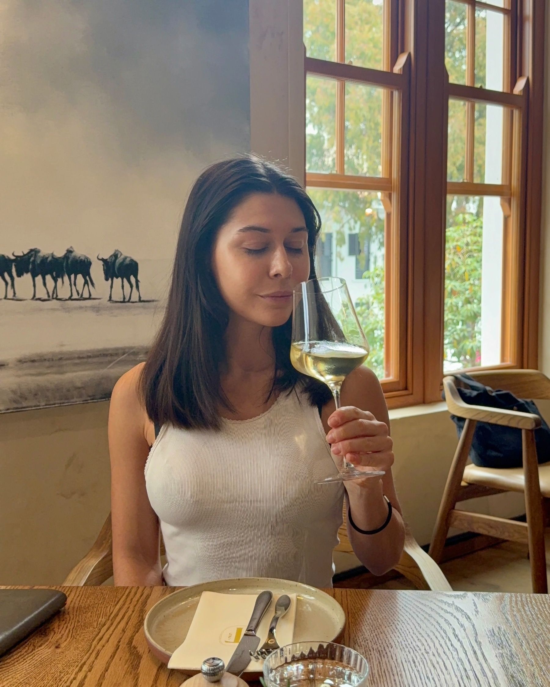 Paige smelling white wine at Tannin on Bree wine bar in Cape Town