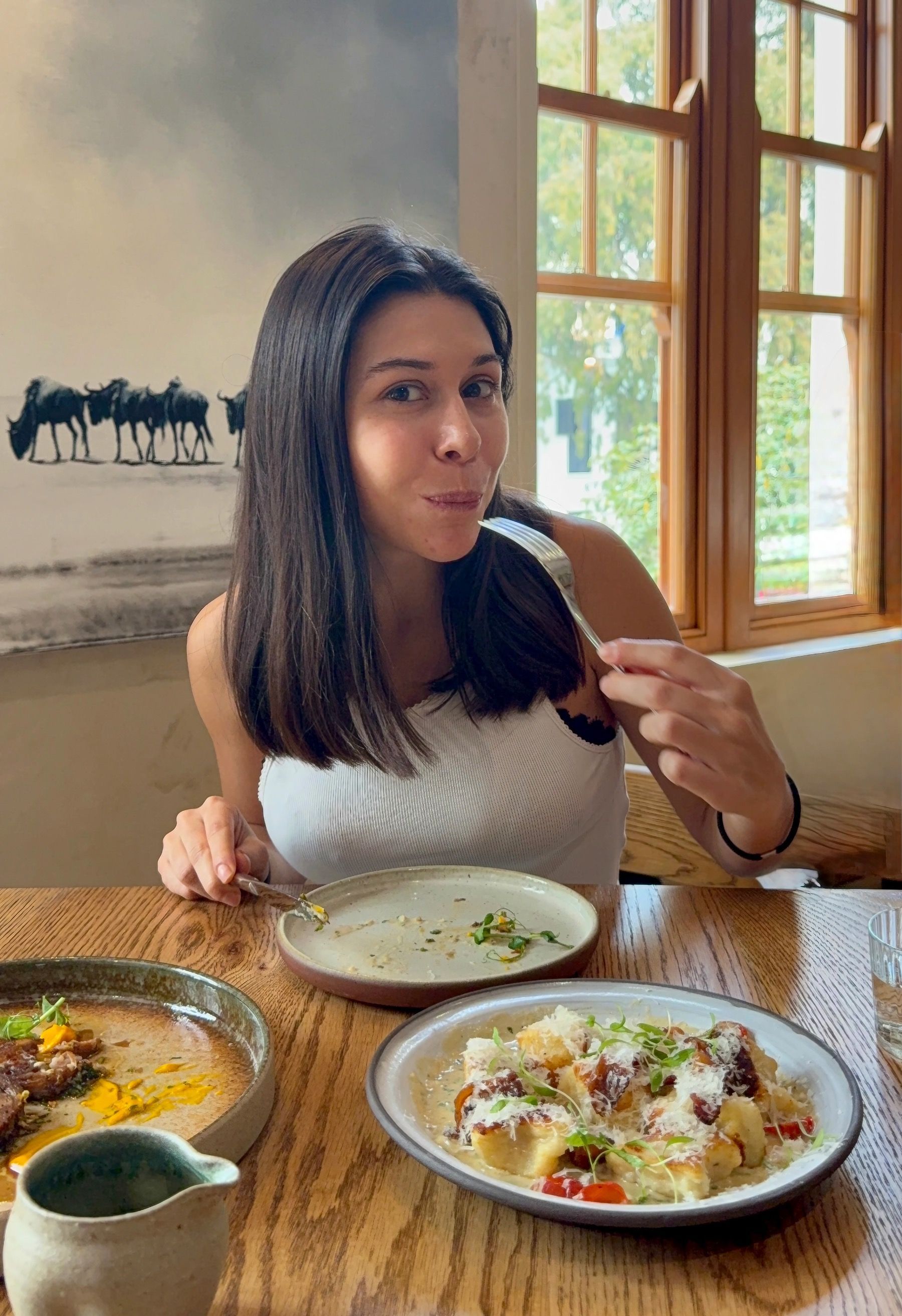Paige eating miso gnocchi with guanciale at Tannin on Bree