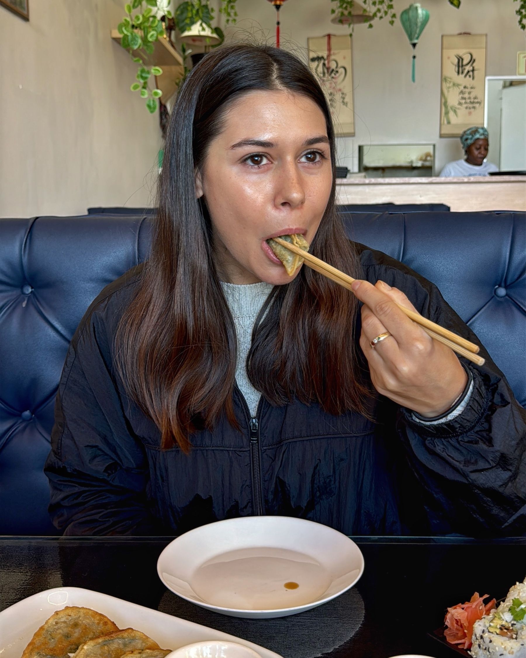 Paige eating pork wontons at Vietnamese Street Kitchen