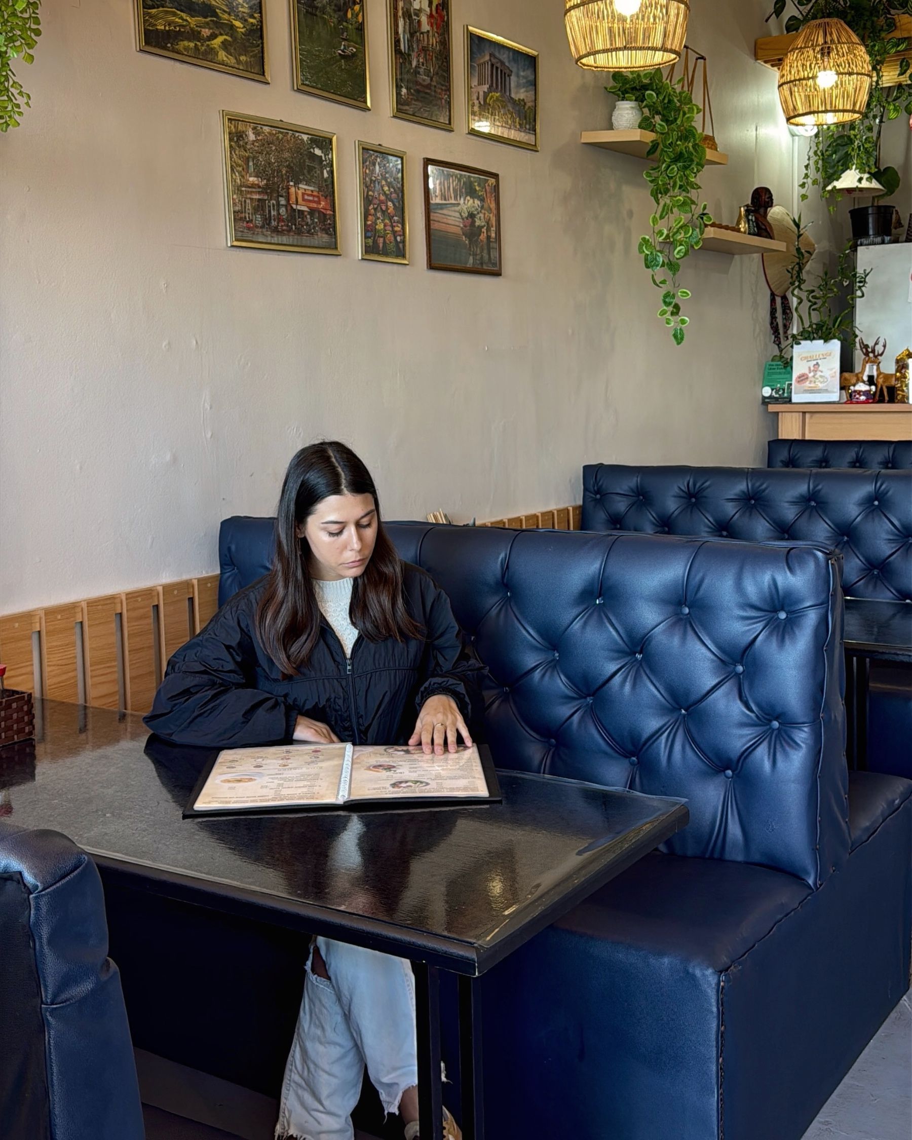 Paige reading the menu at Vietnamese Street Kitchen in Muizenberg