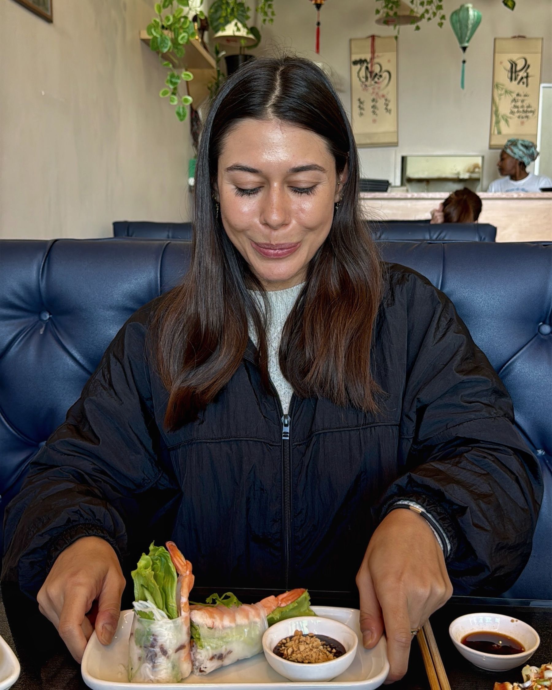 Paige eating fresh prawn spring rolls at Vietnamese Street Kitchen