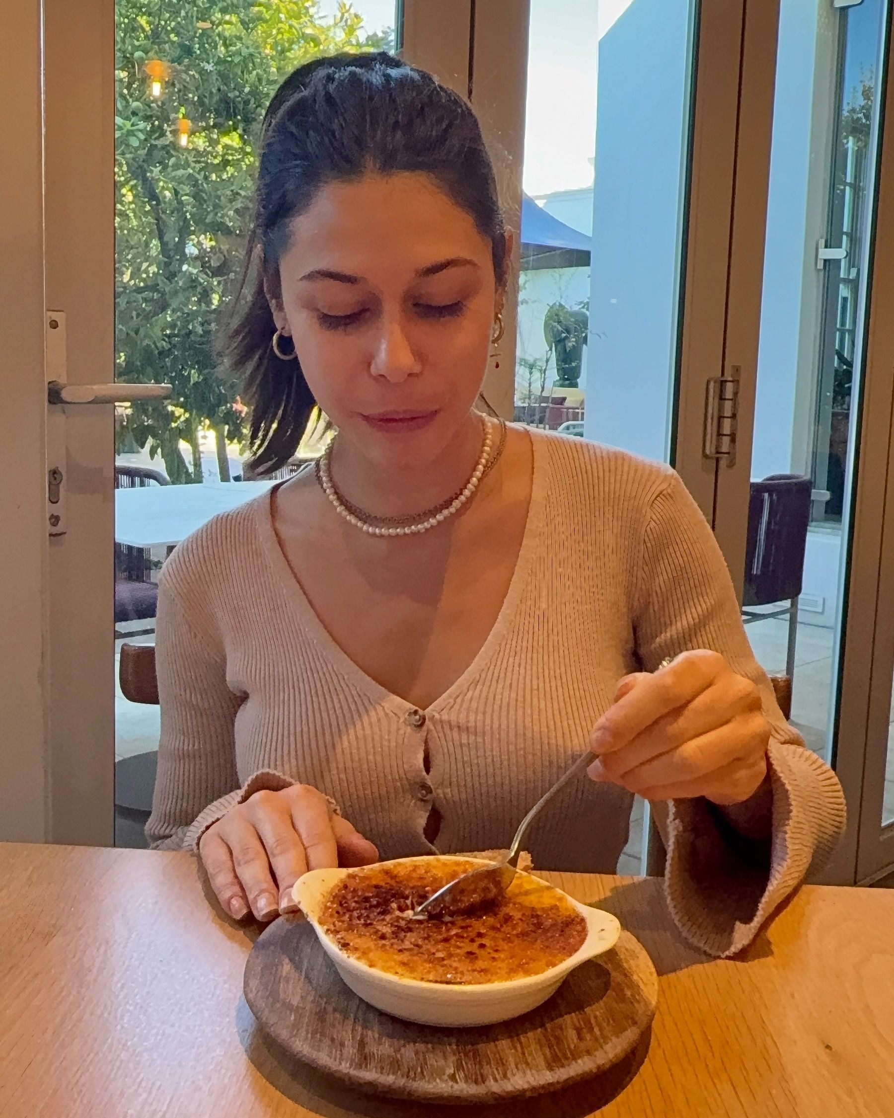 Paige tasting crème brûlée dessert at Tryn