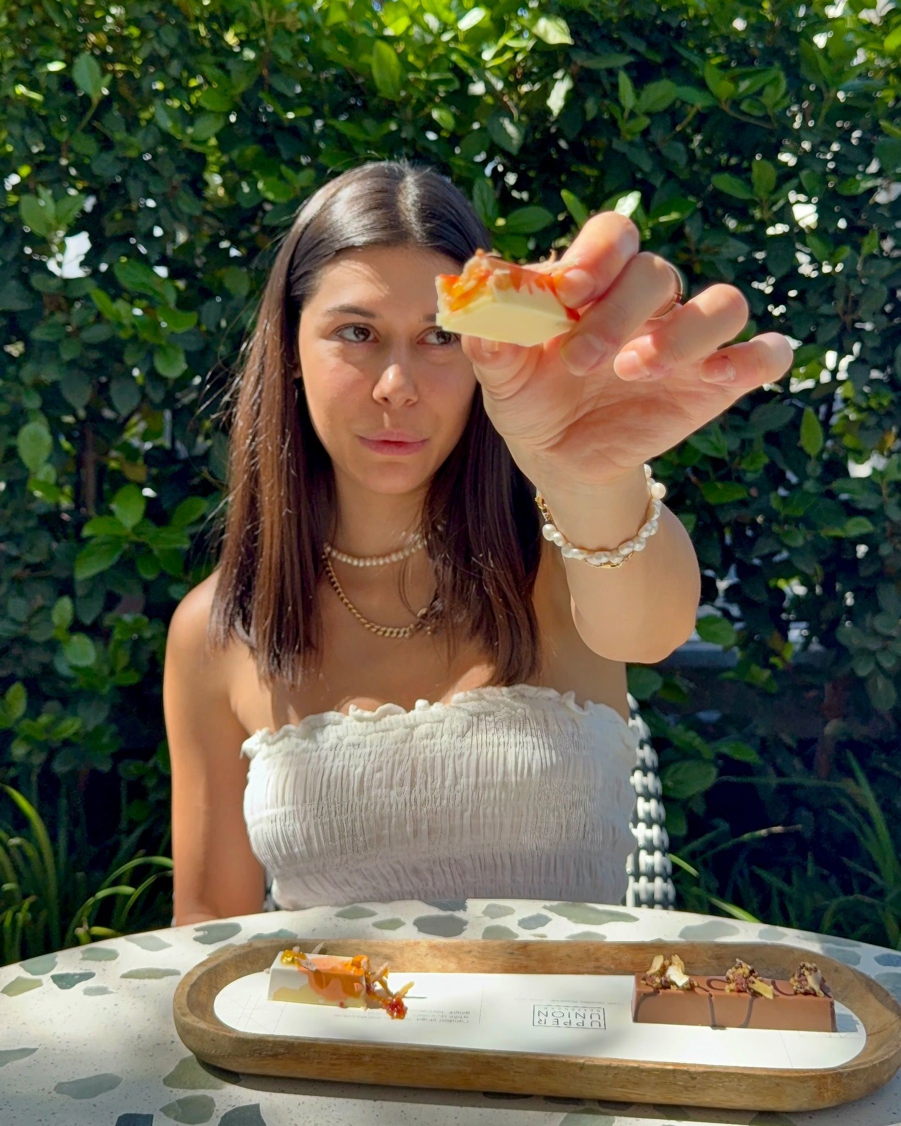 Paige holding chocolate petit four at Upper Union Restaurant Week Cape Town.