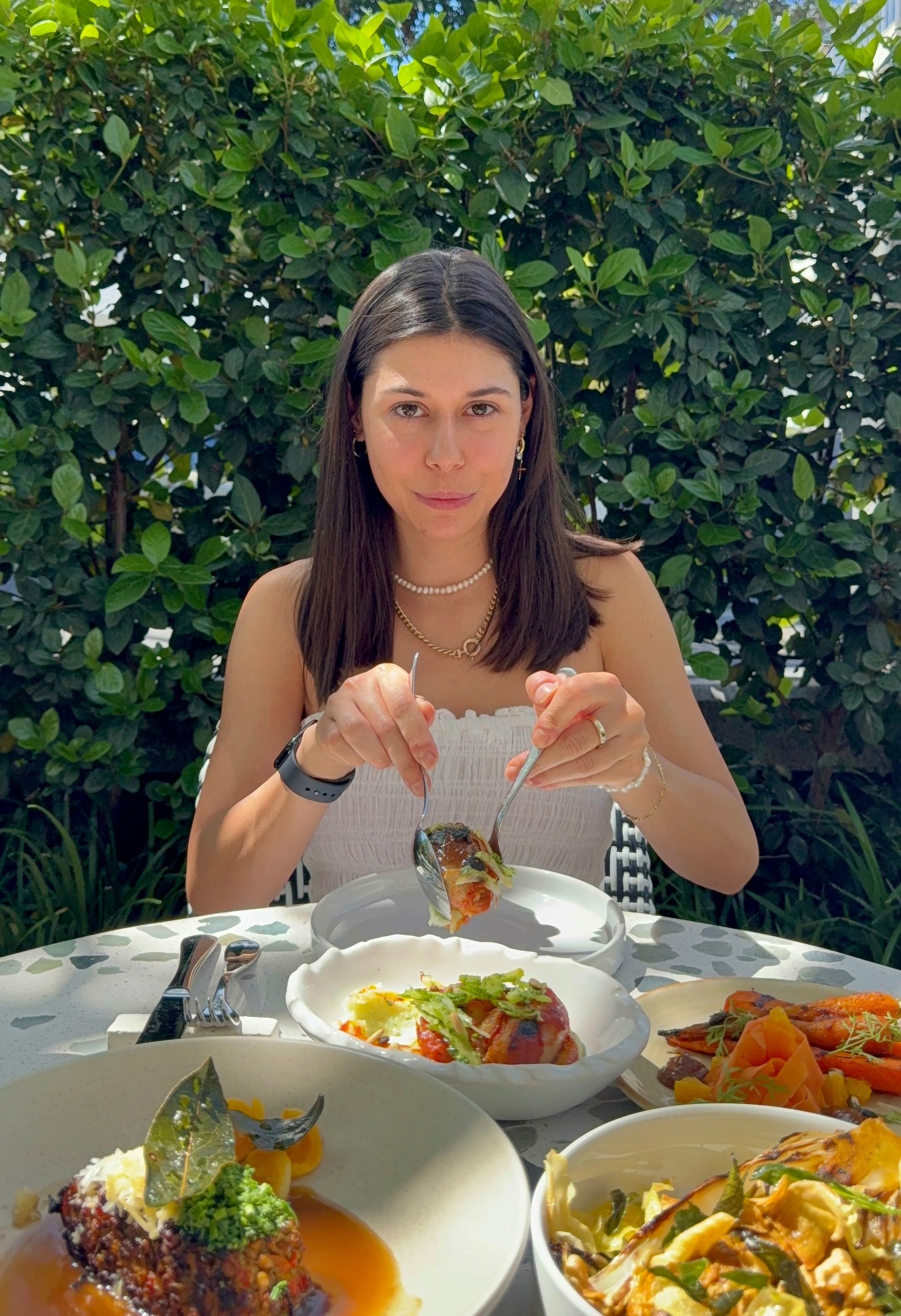 Serving Upper Union Garden menu mains including legume terrine and glazed carrots in courtyard setting