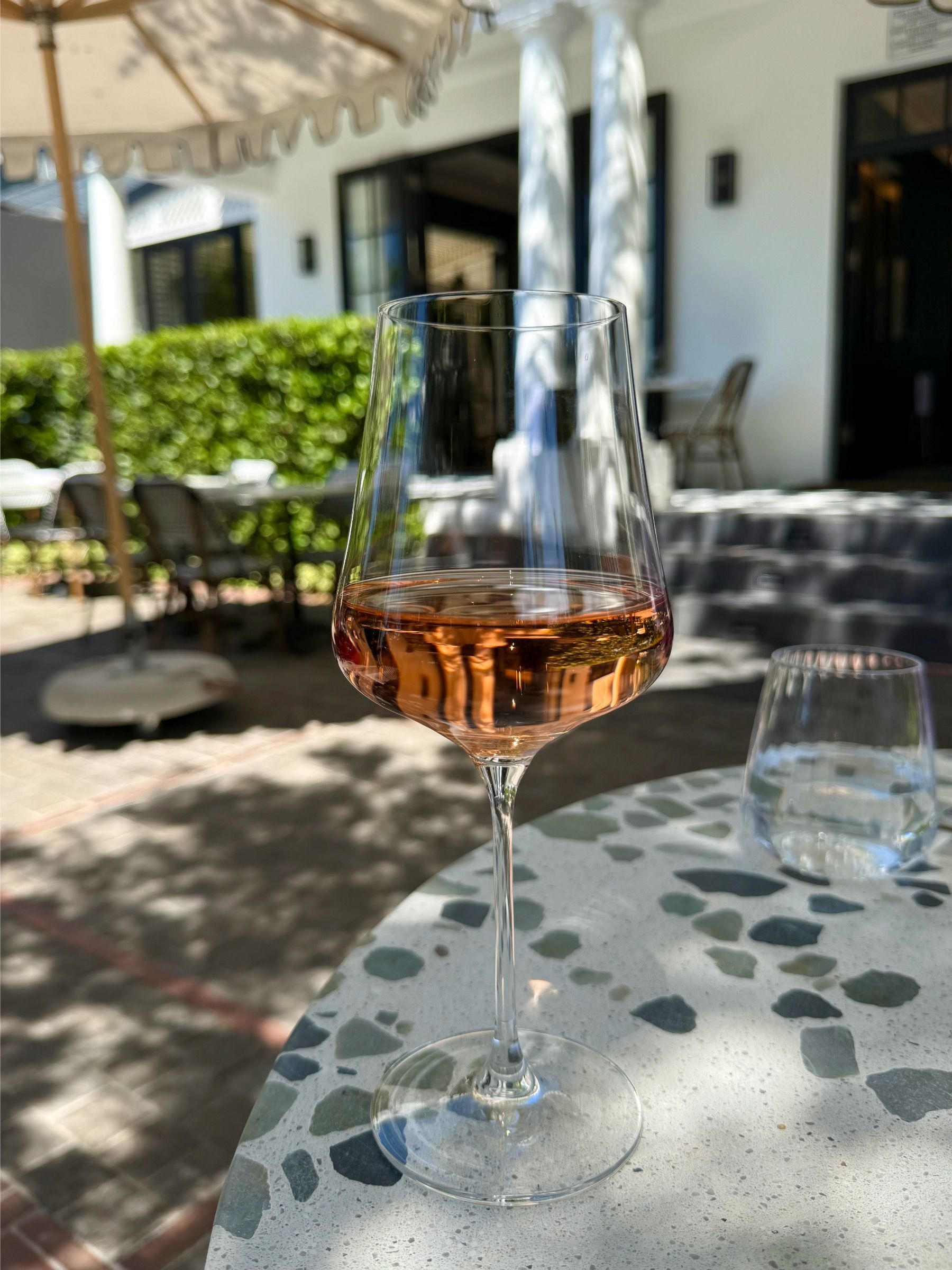 Glass of rosé wine in Upper Union courtyard, Cape Town restaurant setting