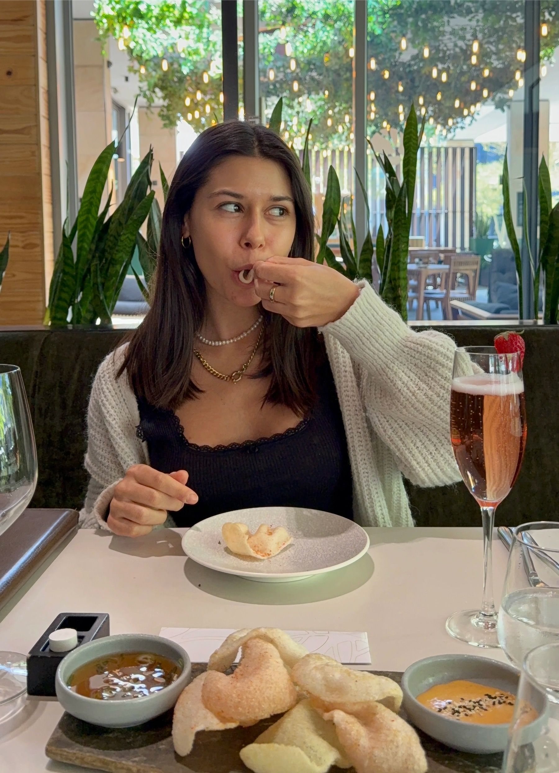 Paige is enjoying prawn crackers served with dipping sauces at Urban Umami in Century City