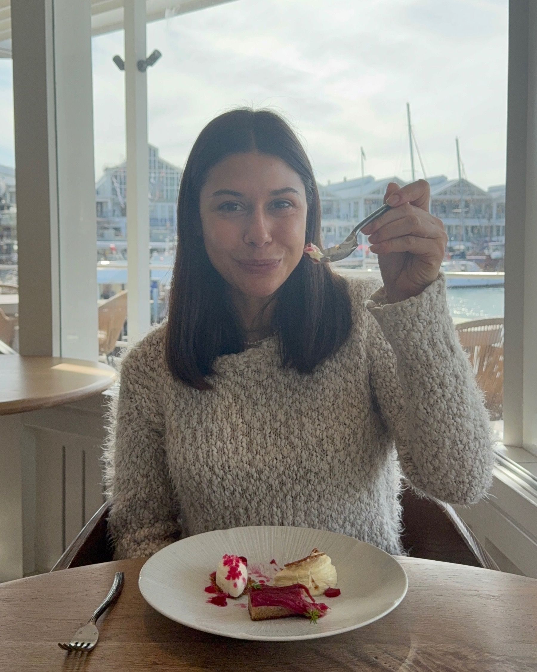 Paige tasting the rhubarb tart dessert with ice cream at The Waterside.
