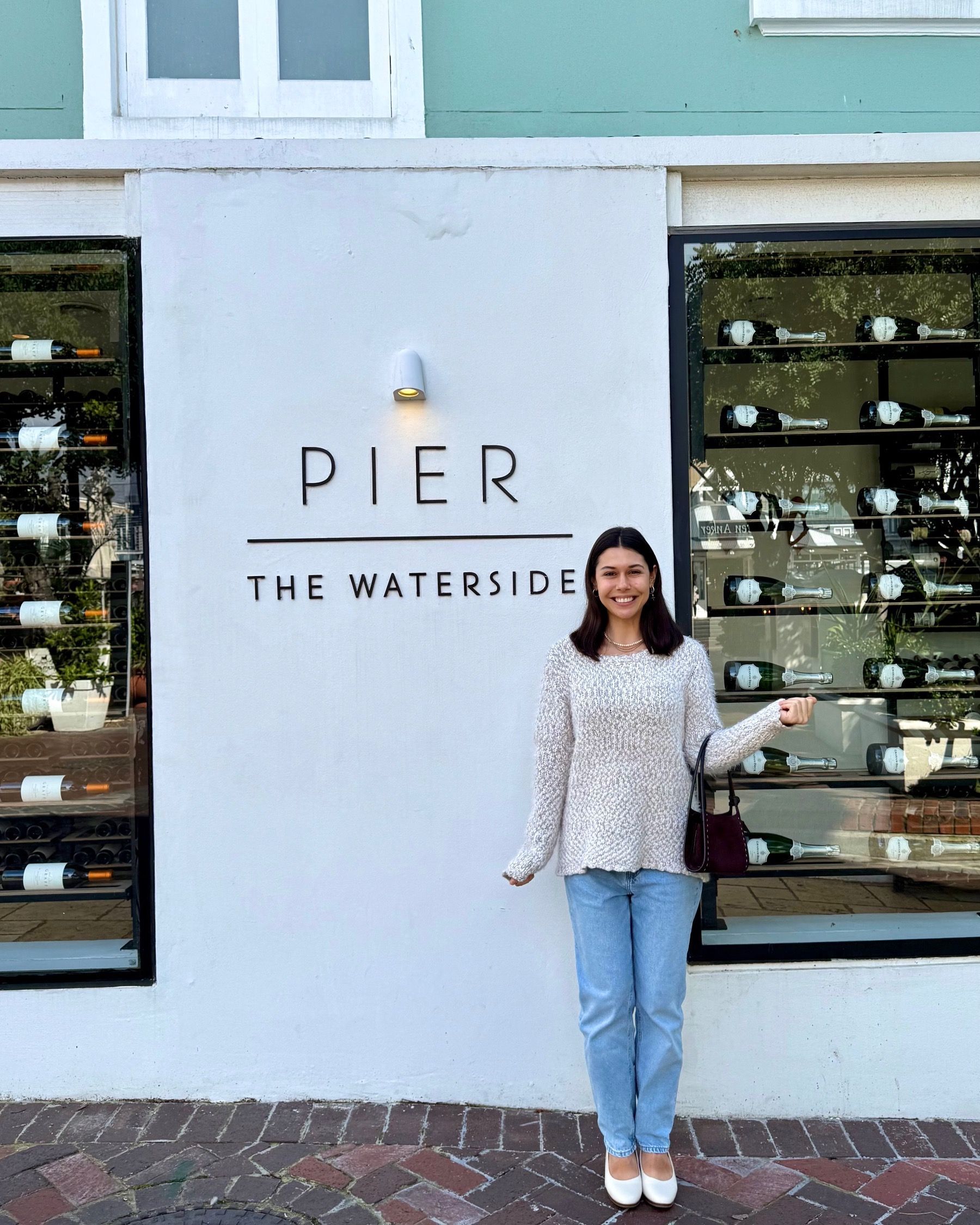 Paige posing outside The Waterside restaurant at the V&A Waterfront in Cape Town.