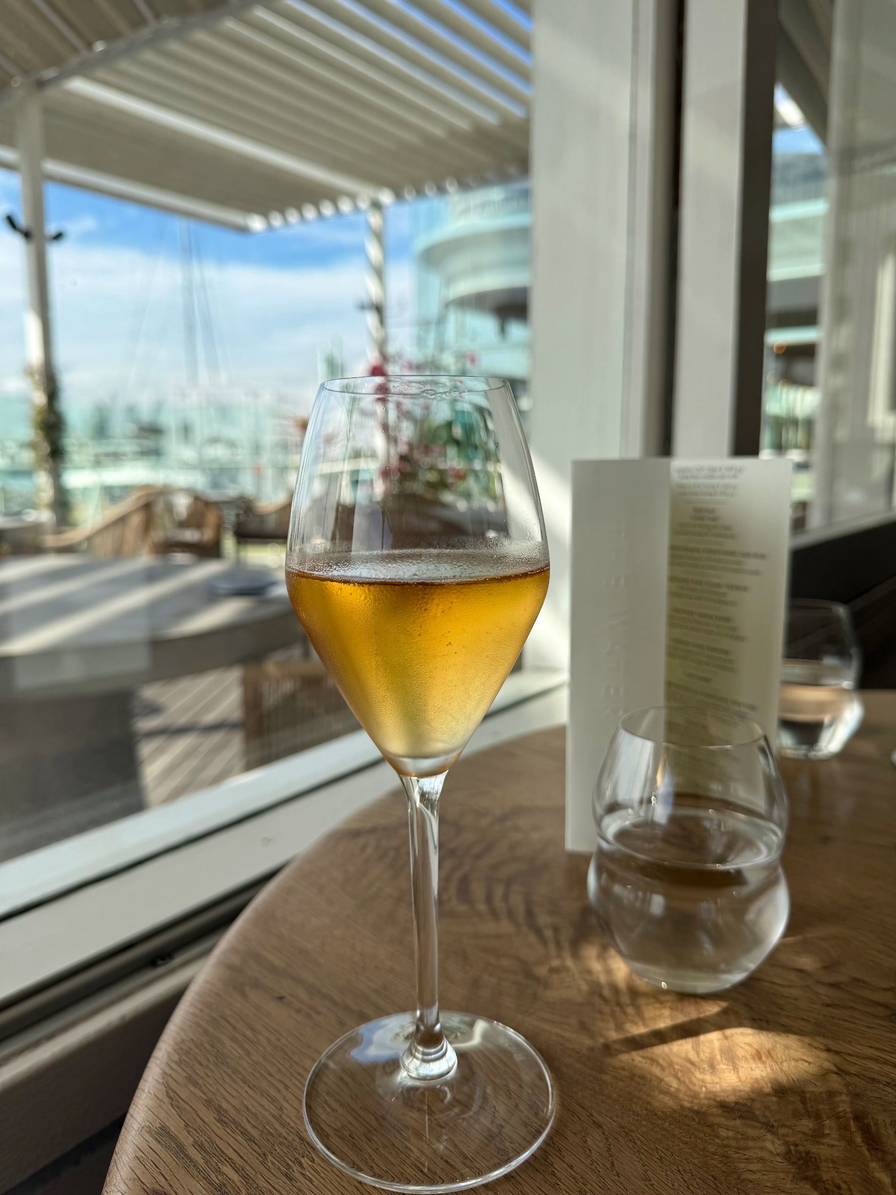 Glass of chilled rosé MCC served at The Waterside with harbour views.
