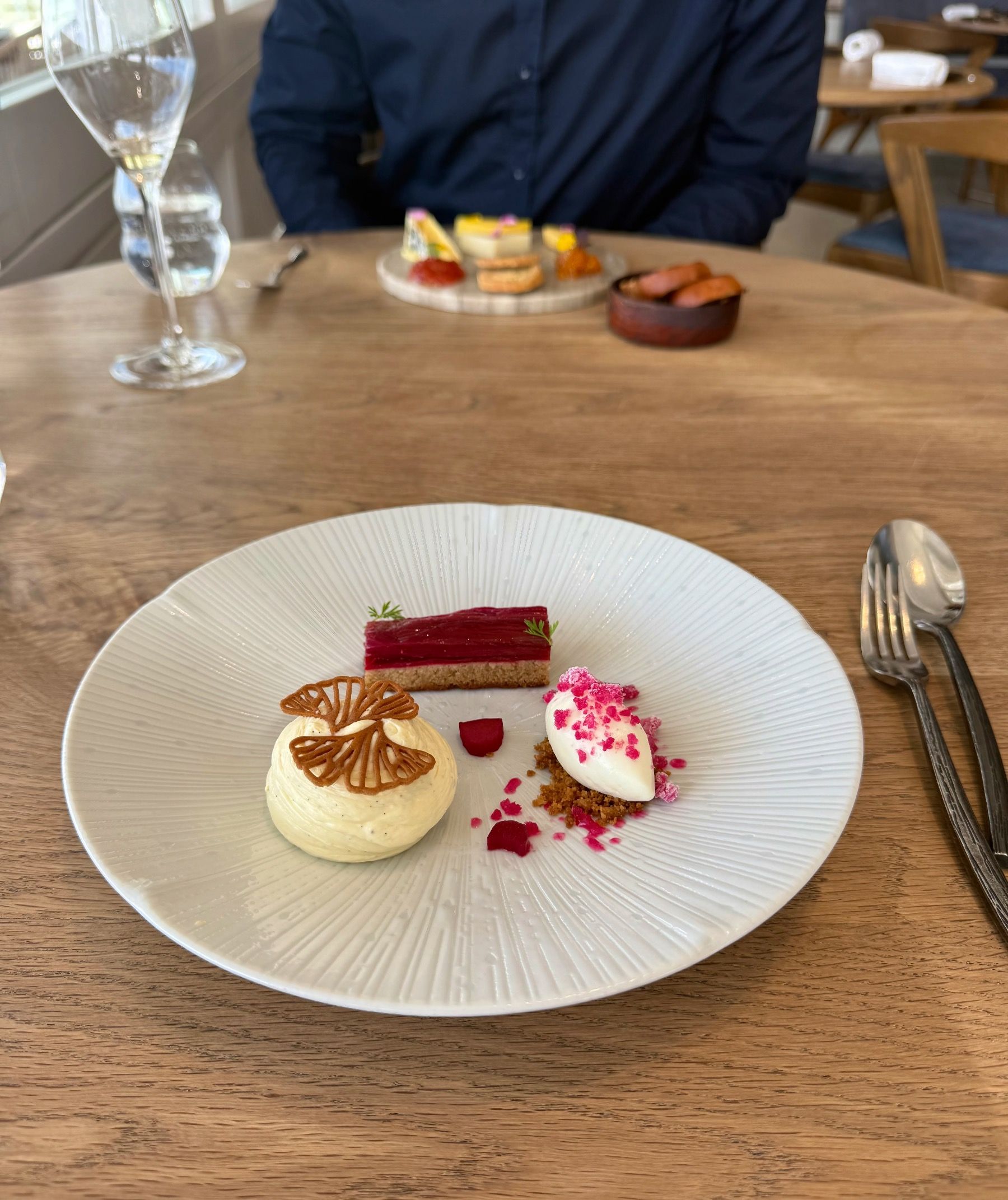 Elegant rhubarb tart with cheesecake elements and ice cream at The Waterside.

