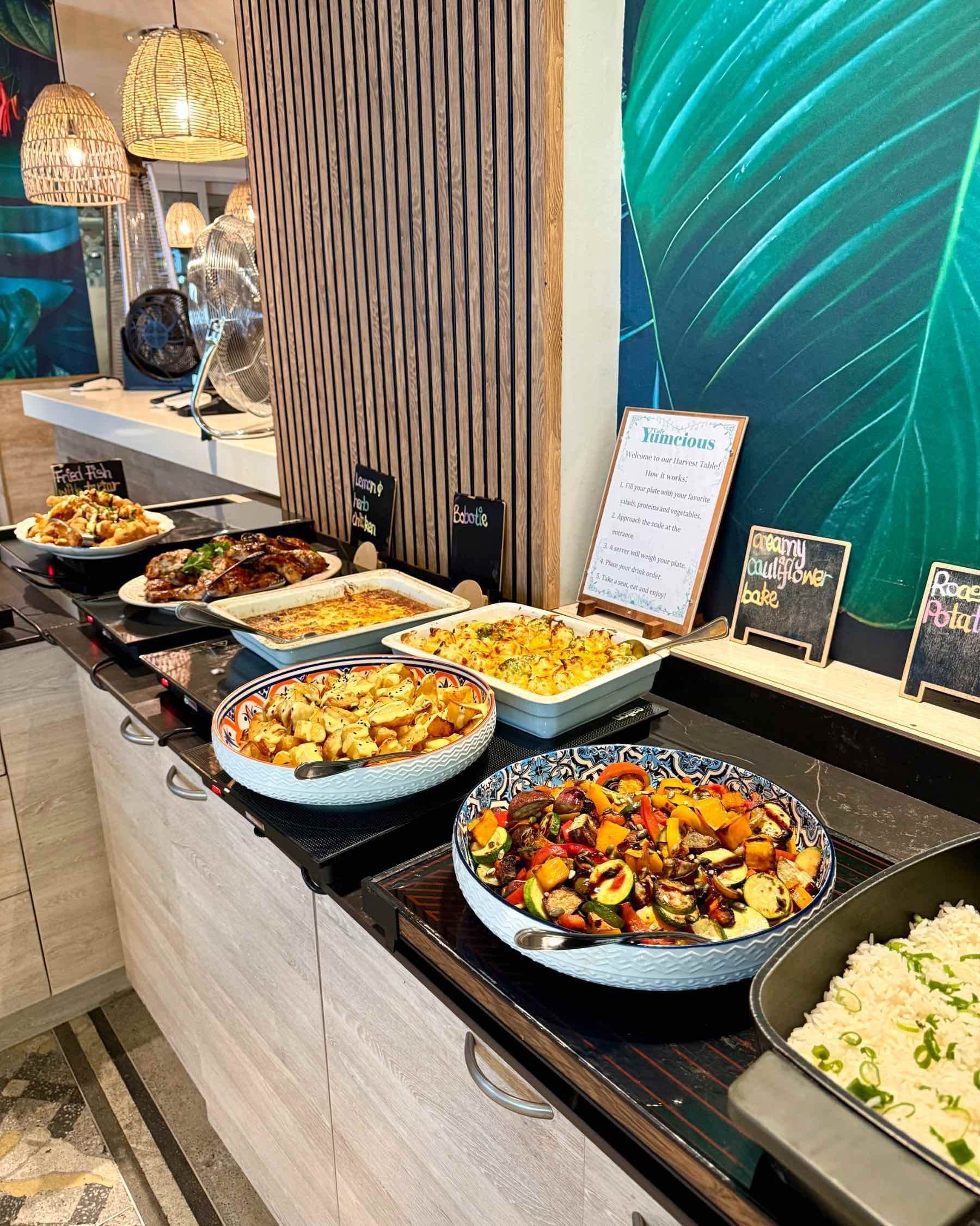 Warm dishes at Yumcious Cape Quarter Harvest Table in Cape Town, featuring roasted vegetables and seasonal comfort food.