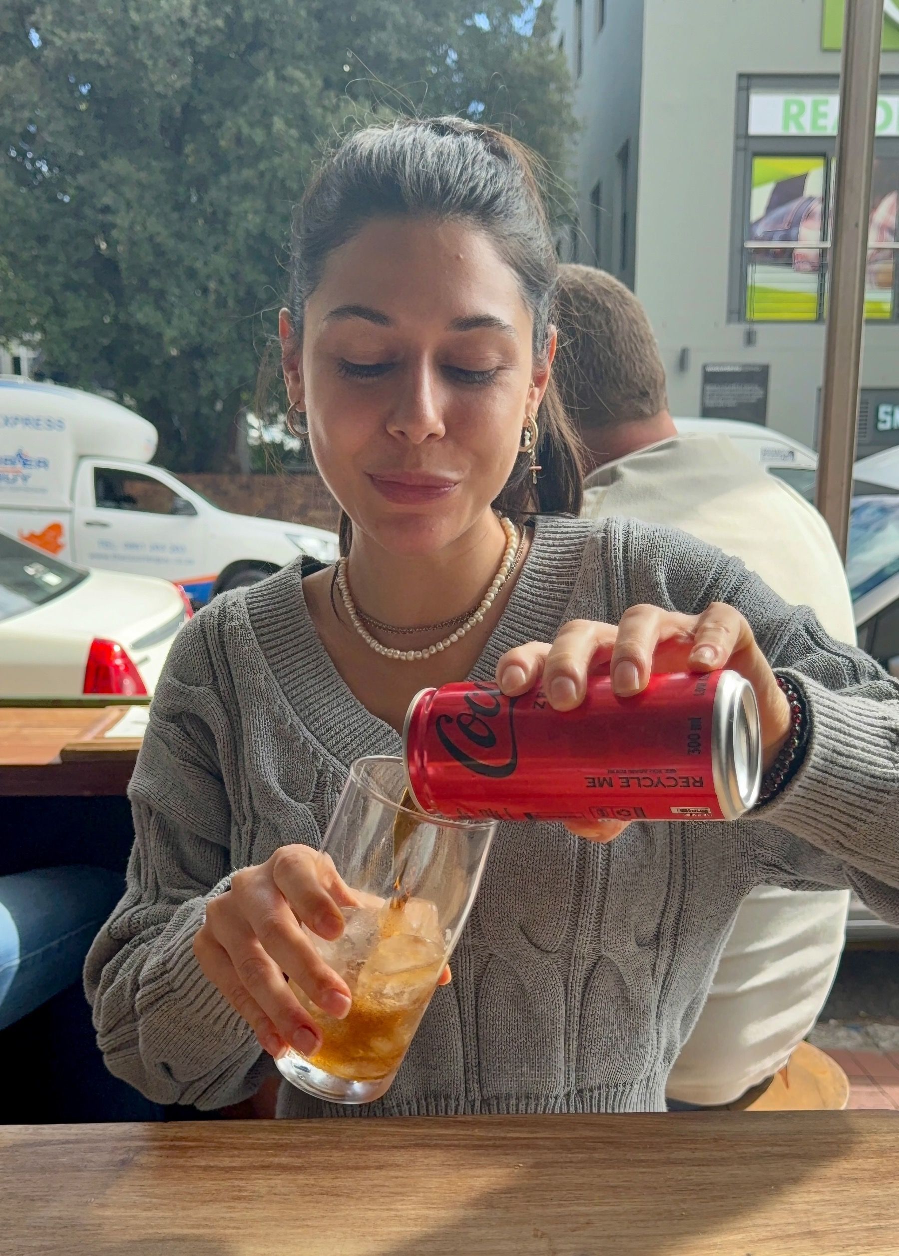 Paige pouring Coke Zero at Zuney burger restaurant Cape Town
