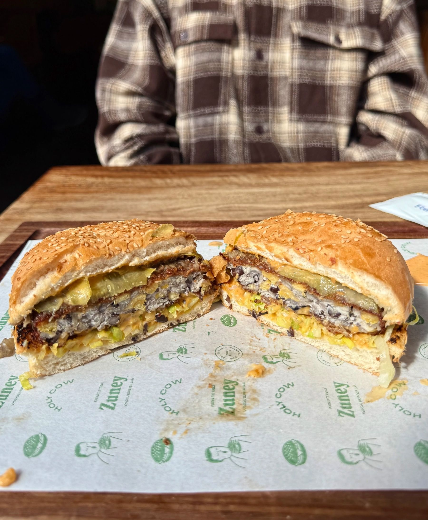 Halved vegan tempeh burger at Zuney Cape Town with layered fillings visible