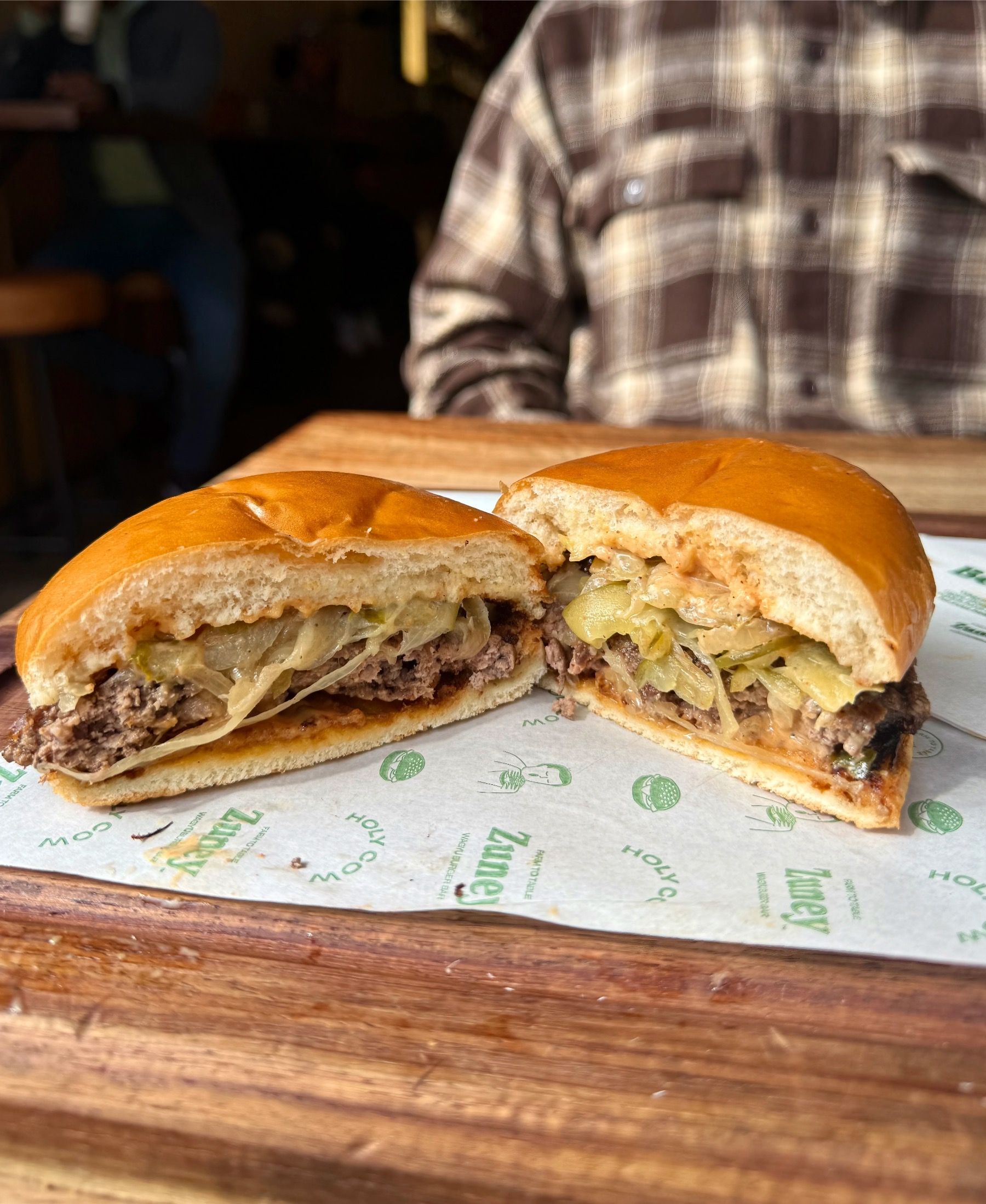 Zuney smashed beef burger cross-section with pickles and house sauce