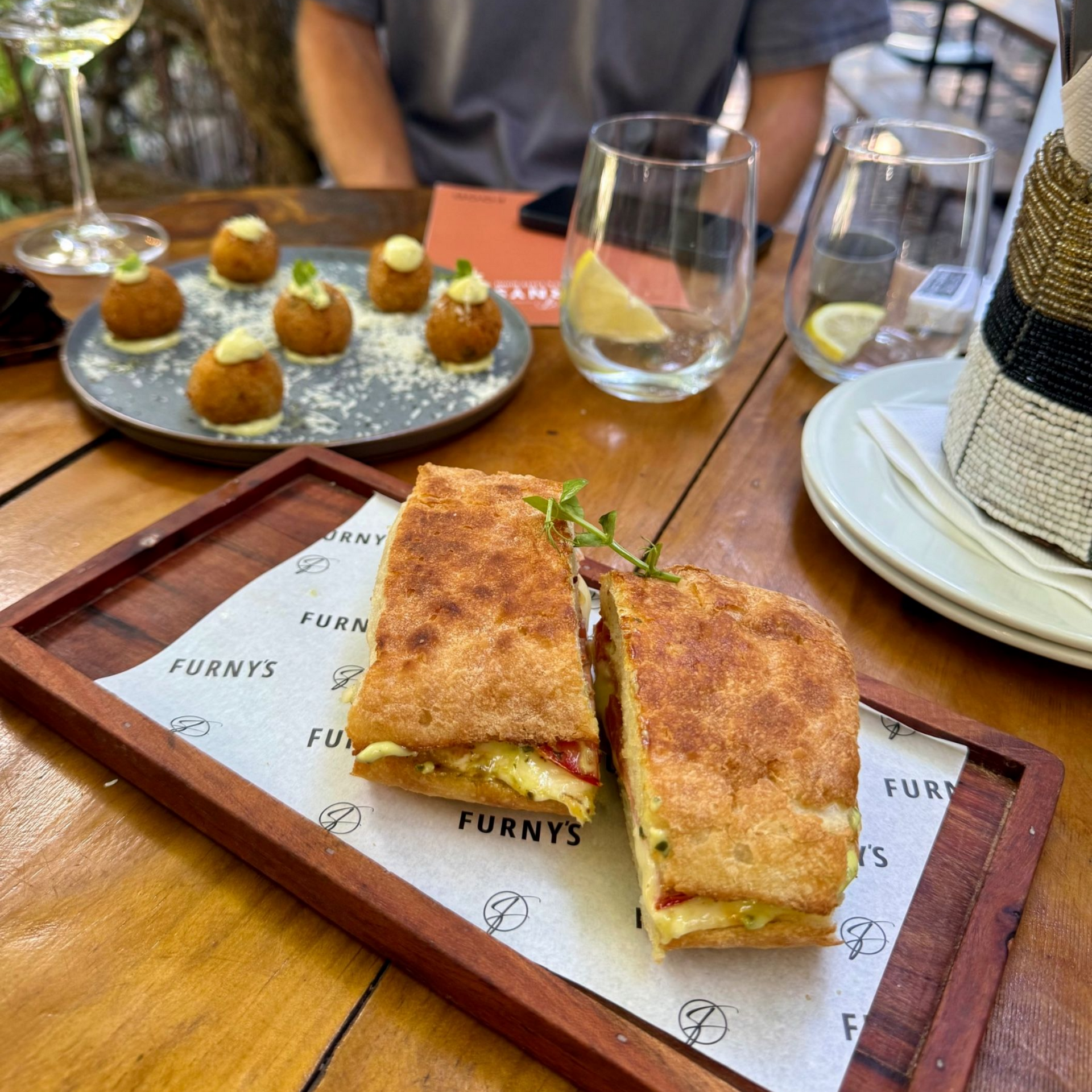 Furney’s Wine Bar truffle arancini and mozzarella pesto tomato toasted sandwich
