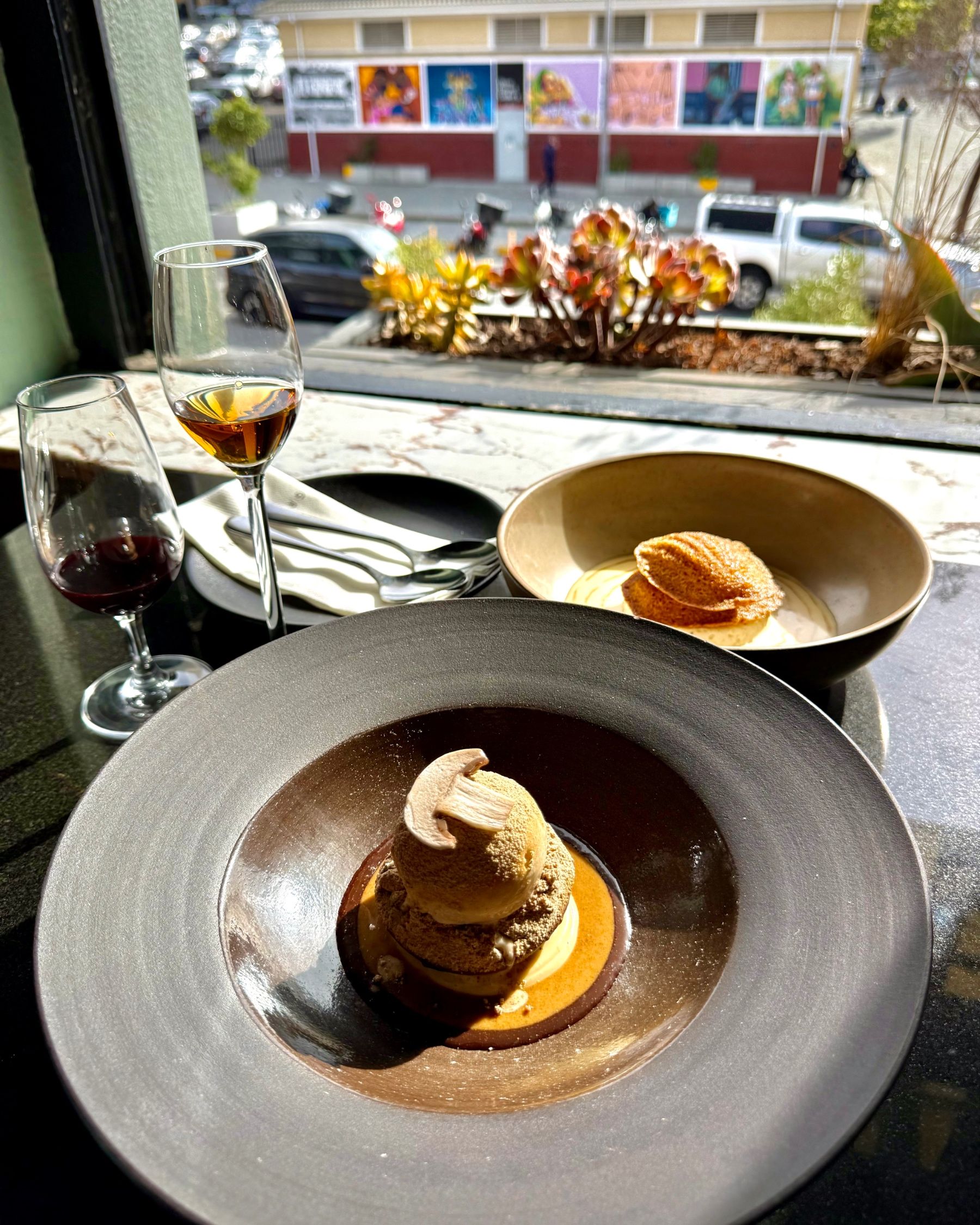 Classic tiramisu served in a glass dessert dish.