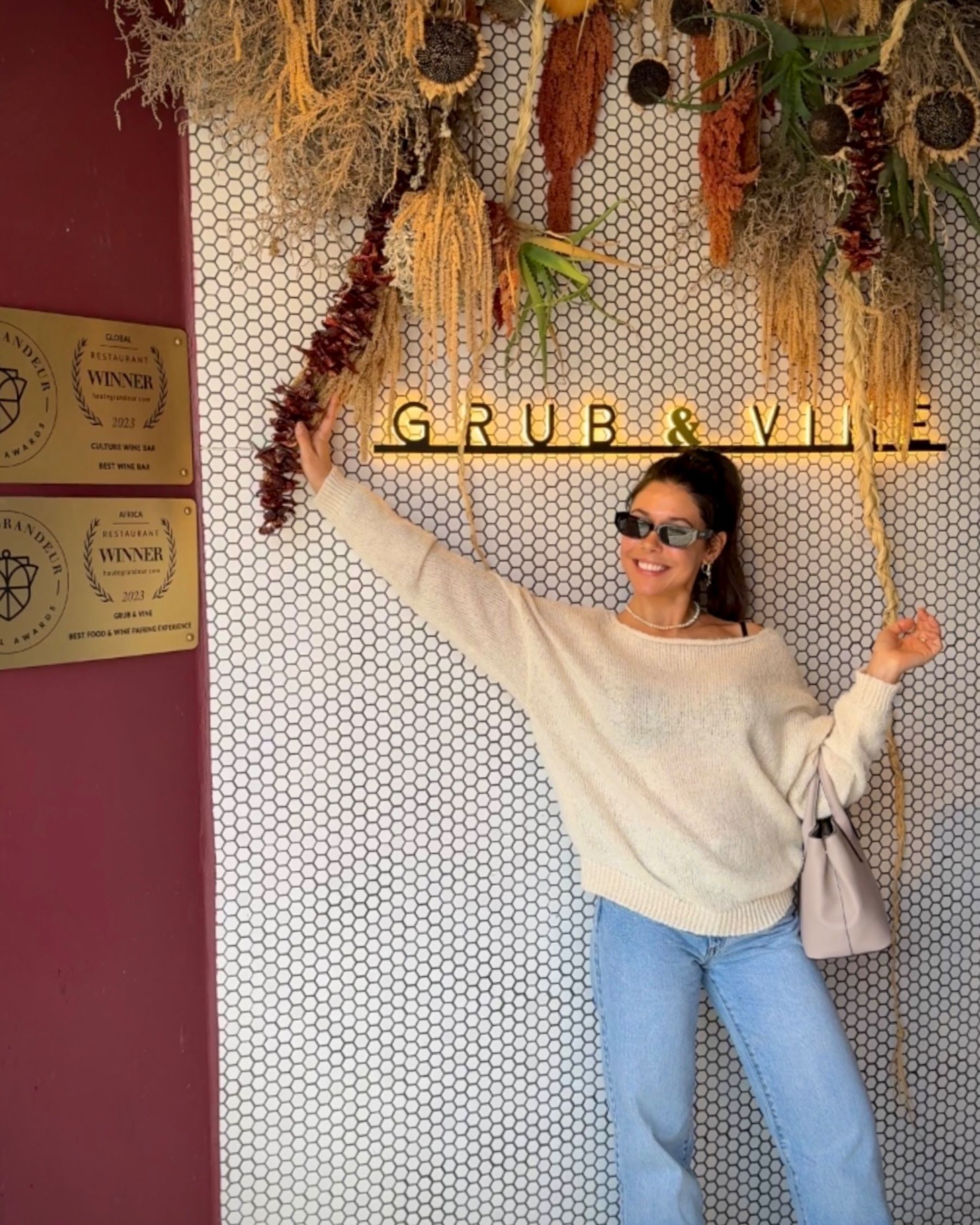 Paige standing beside the Massimo’s entrance sign.