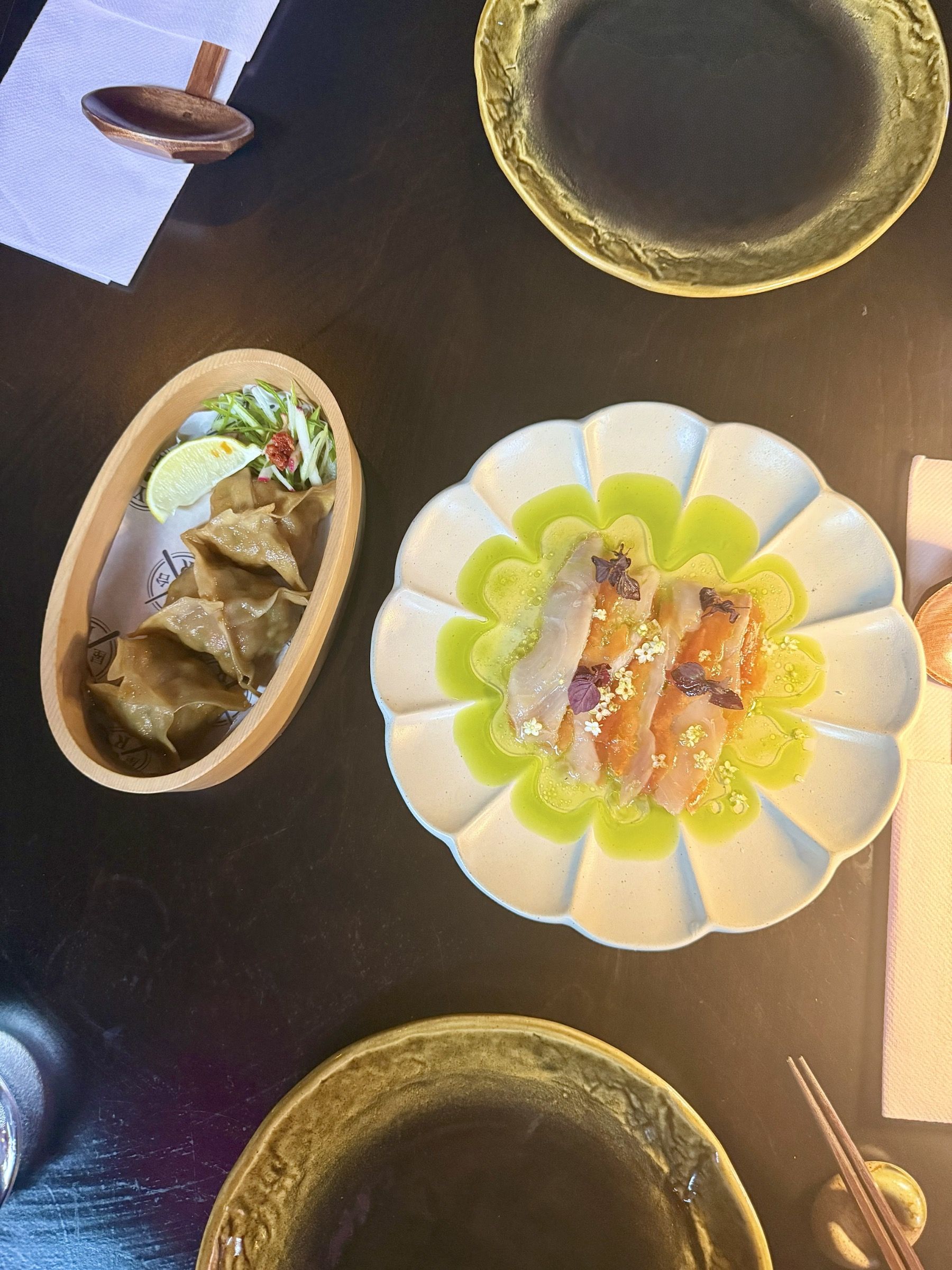 Yatai Ramen Bar prawn dumplings with lime and yellowtail sashimi with pickled papaya and citrus dressing