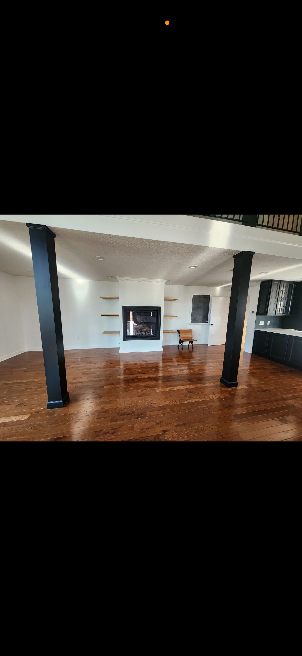 There is a fireplace in the middle of the room.