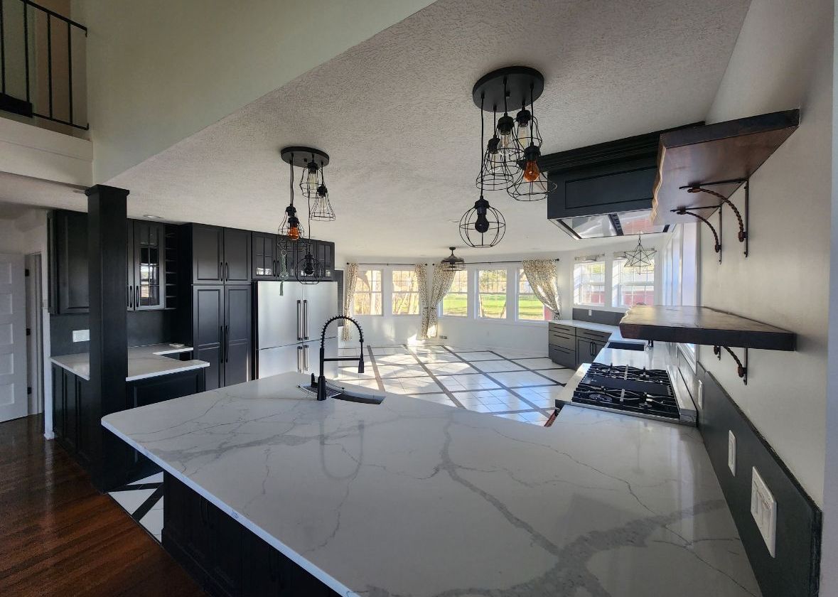 A kitchen with a large island and a stove top oven.