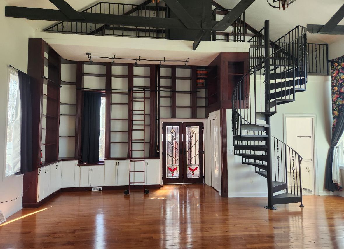 An empty room with a spiral staircase in the middle