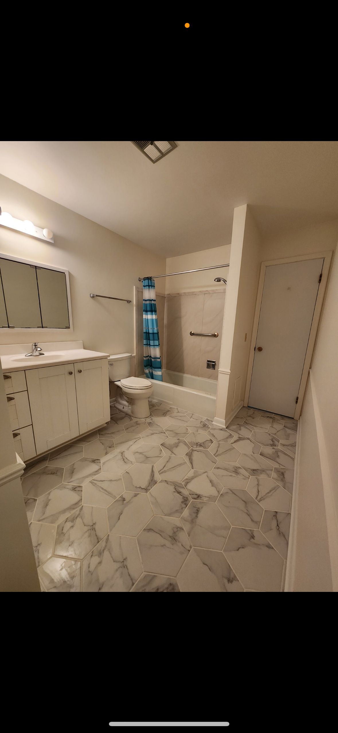 A bathroom with two sinks , a toilet , and a bathtub.