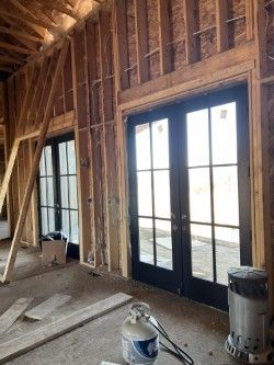 A house is being built with a lot of windows and doors.