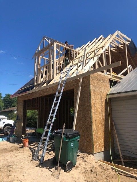 A ladder is sitting on top of a building under construction.