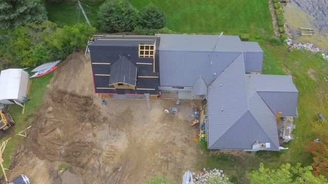 An aerial view of a house under construction in a yard.