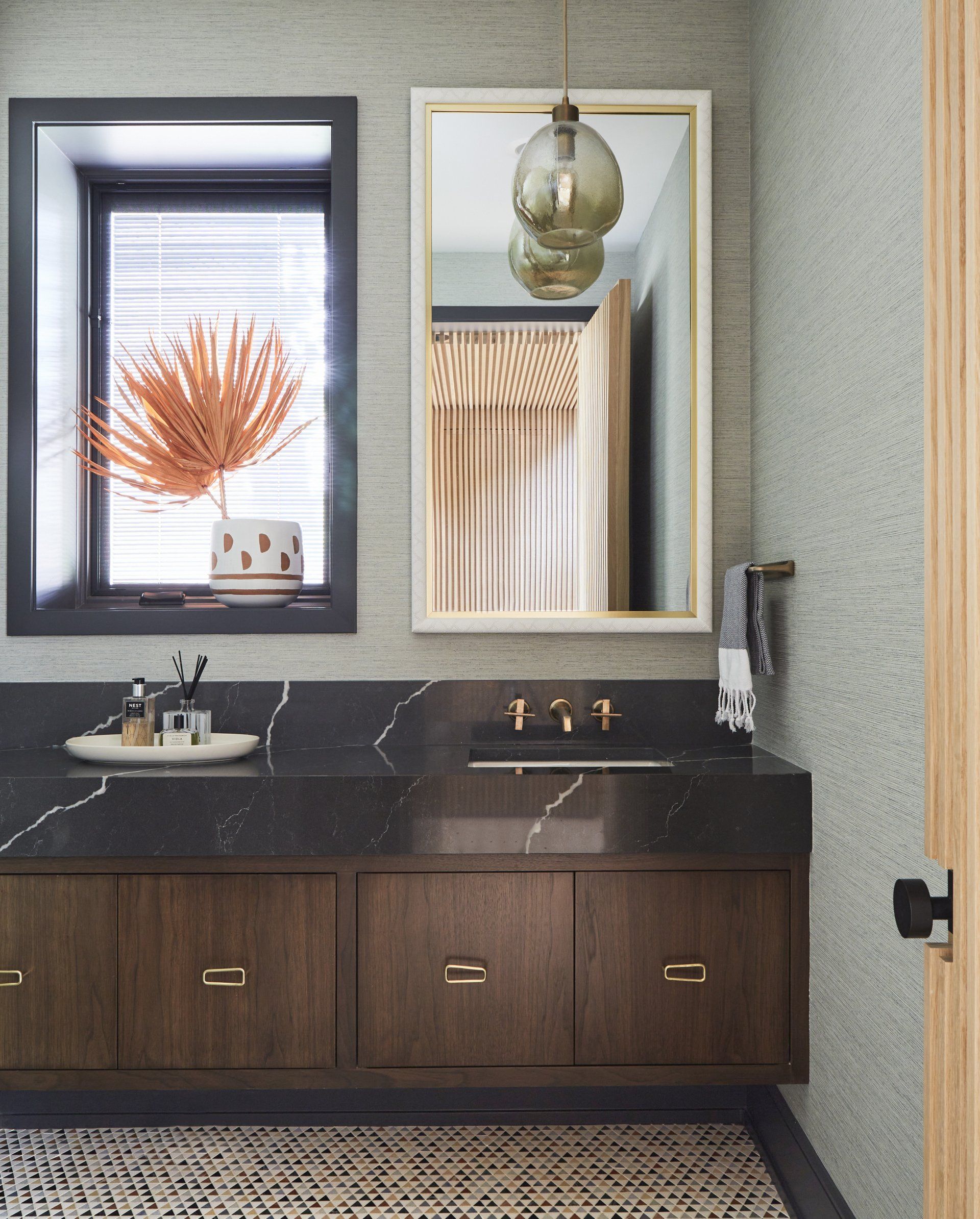 A bathroom with a sink a mirror and a window