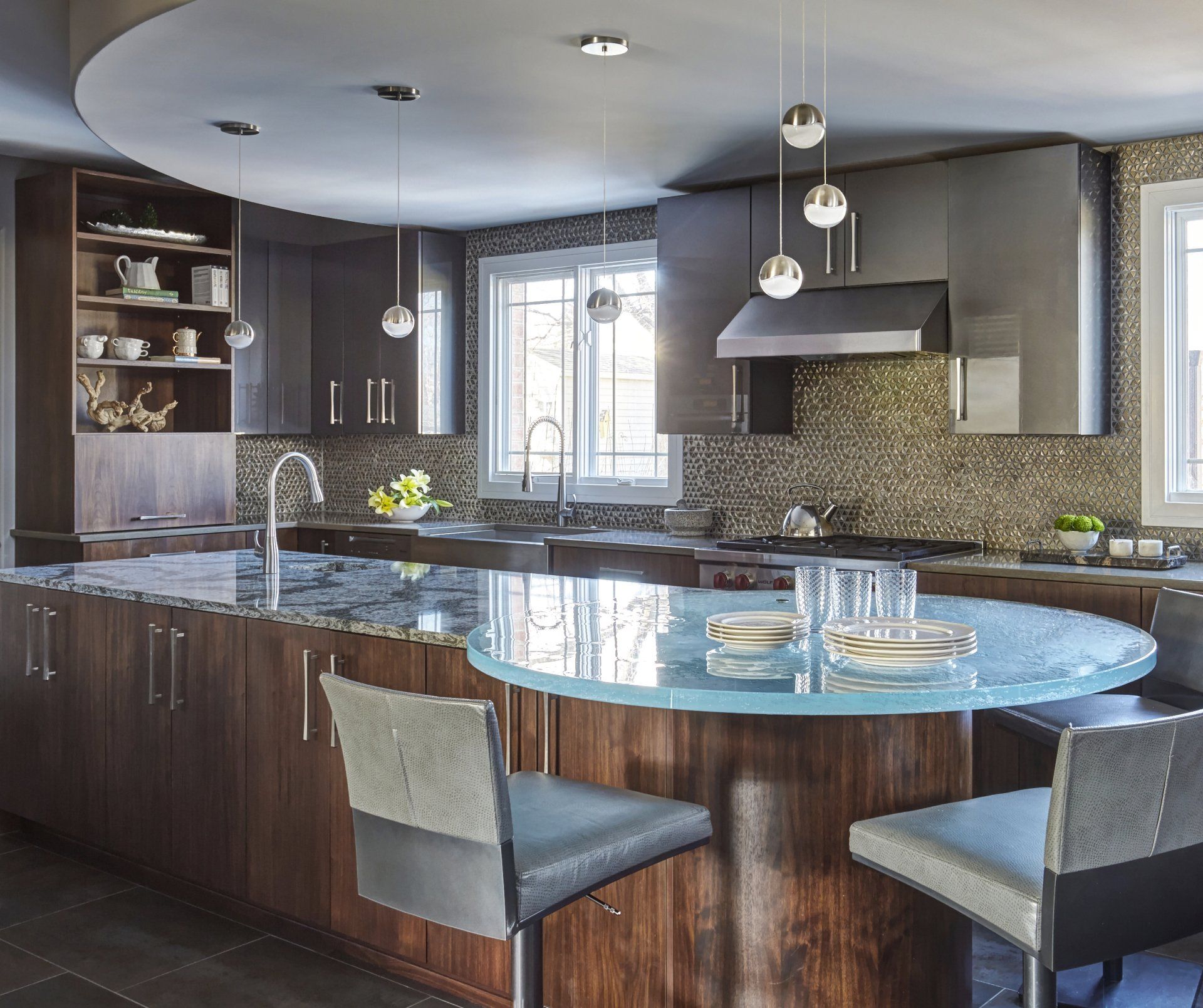 A kitchen with a large island with a glass top