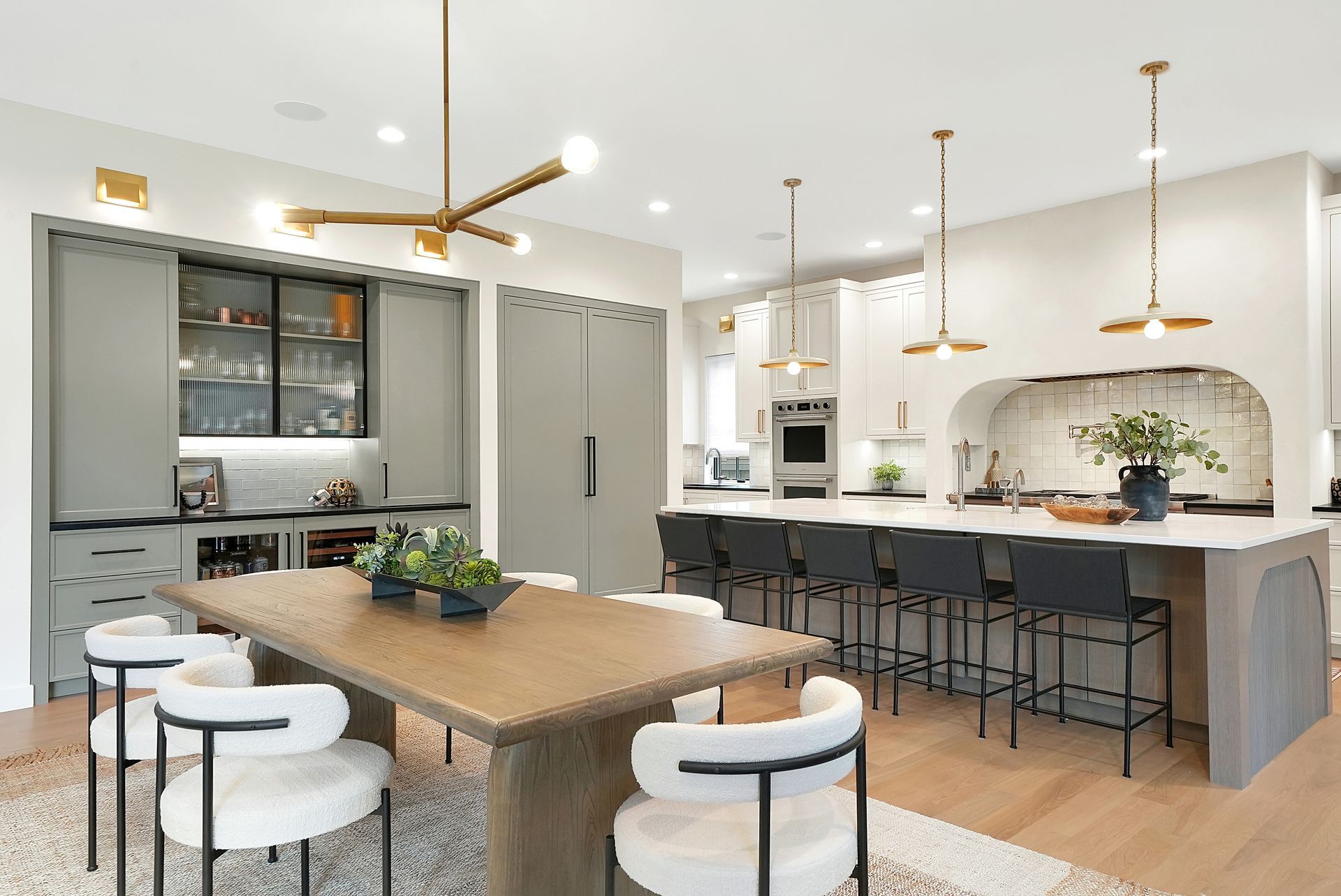 A kitchen with a dining table and chairs and a large island.