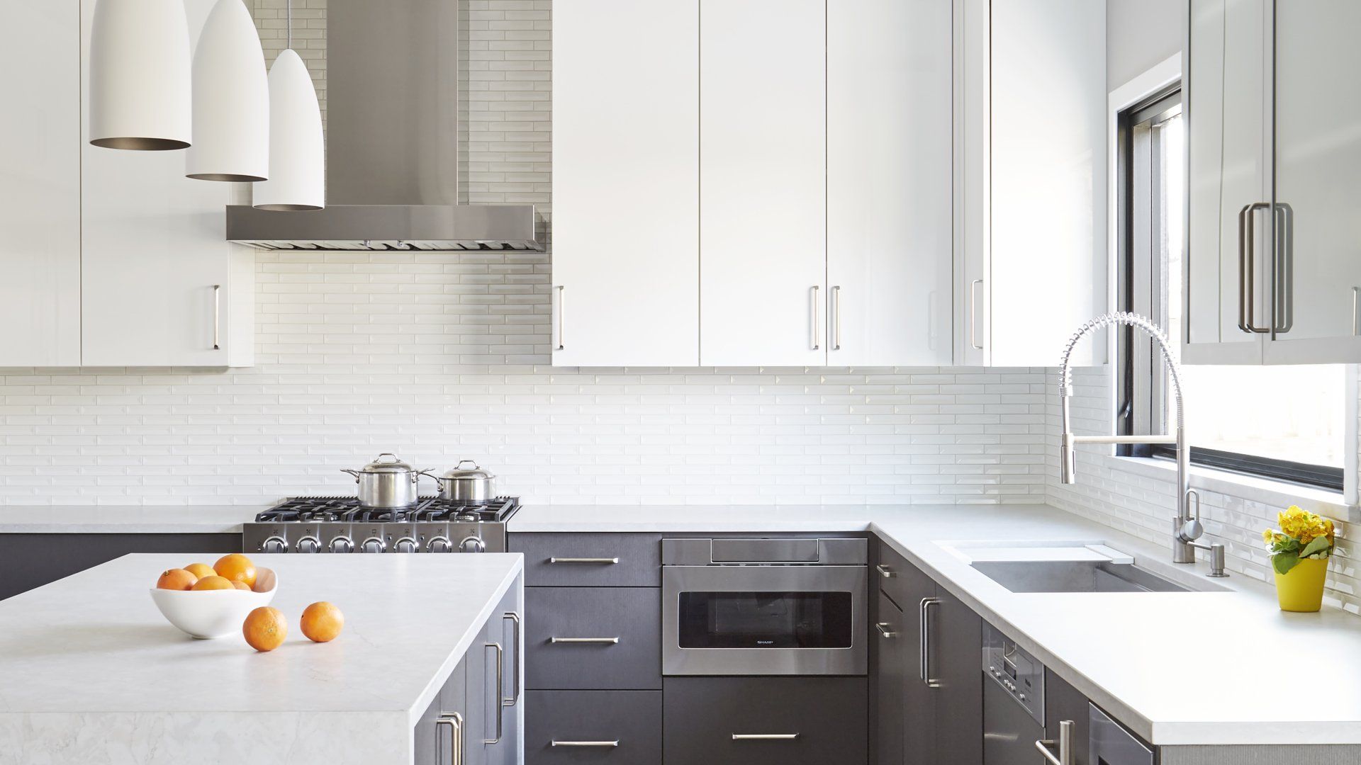 A kitchen with white cabinets and stainless steel appliances