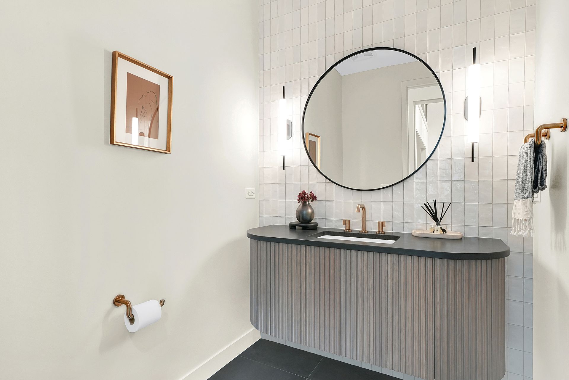 A bathroom with a sink , mirror and towel rack.