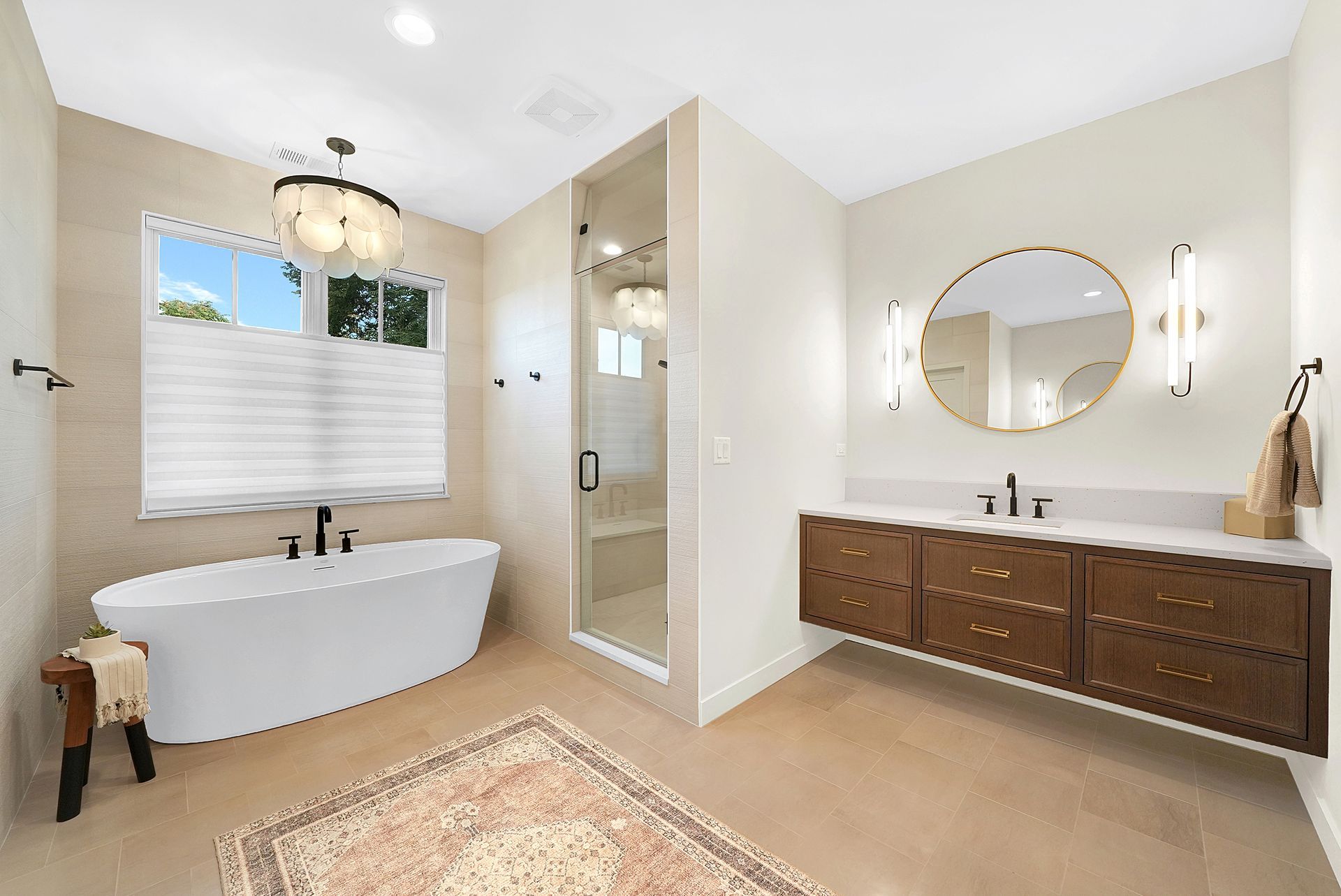 A bathroom with a bathtub , sink , mirror and rug.