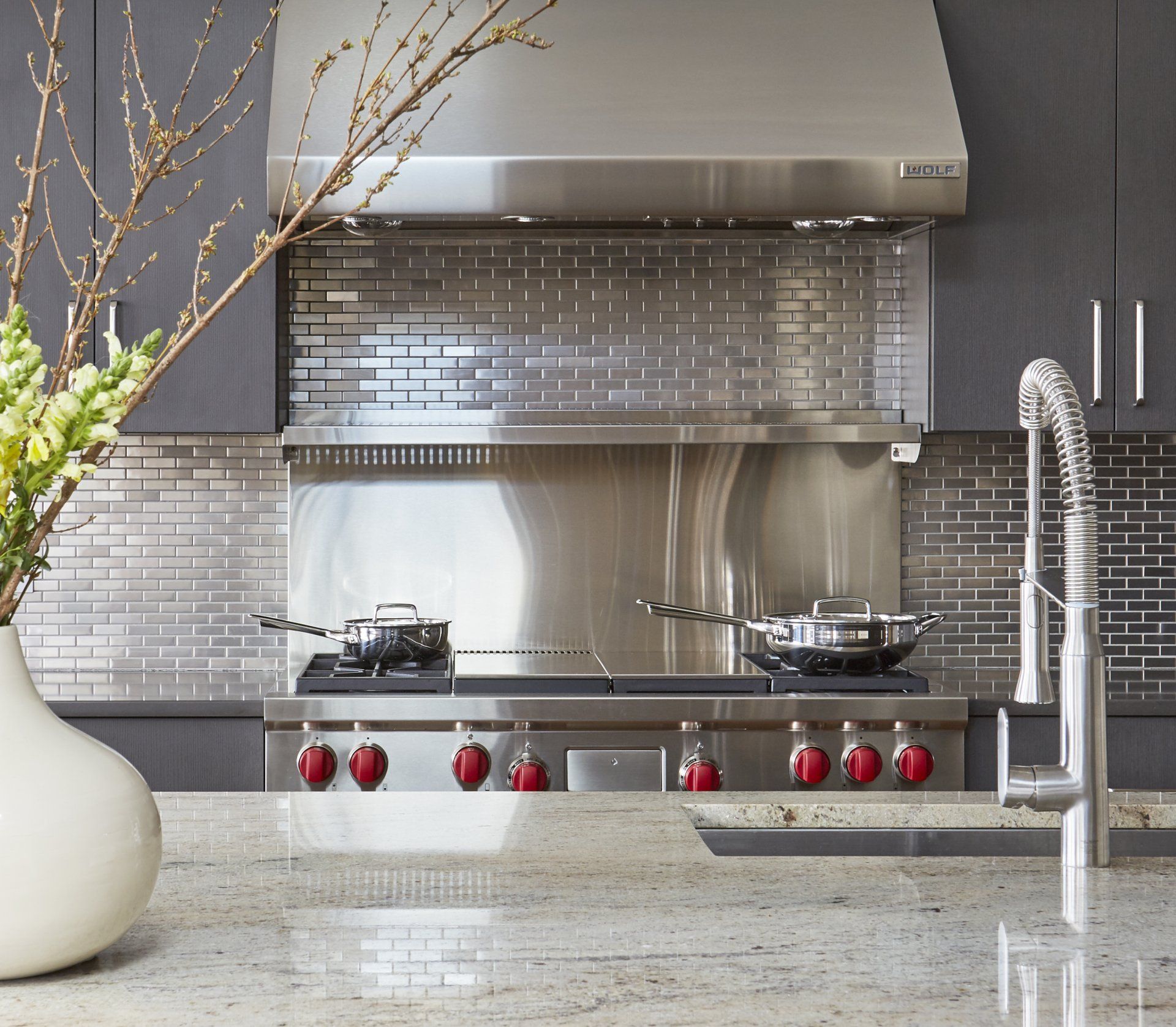 A kitchen with a stove top oven and a sink