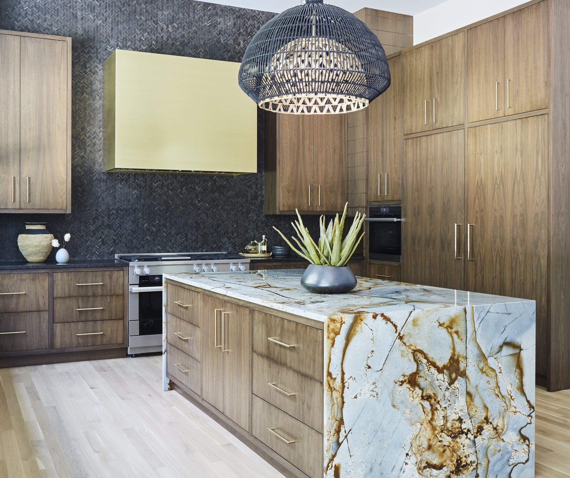 A kitchen with wooden cabinets and a marble counter top