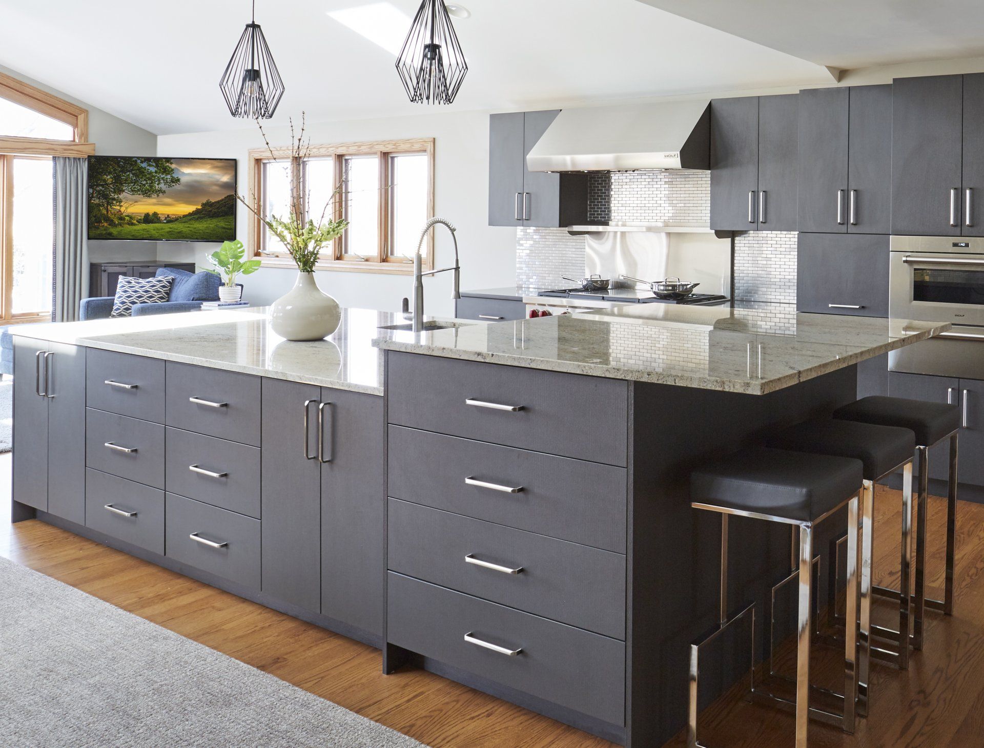 A kitchen with a large island and stools