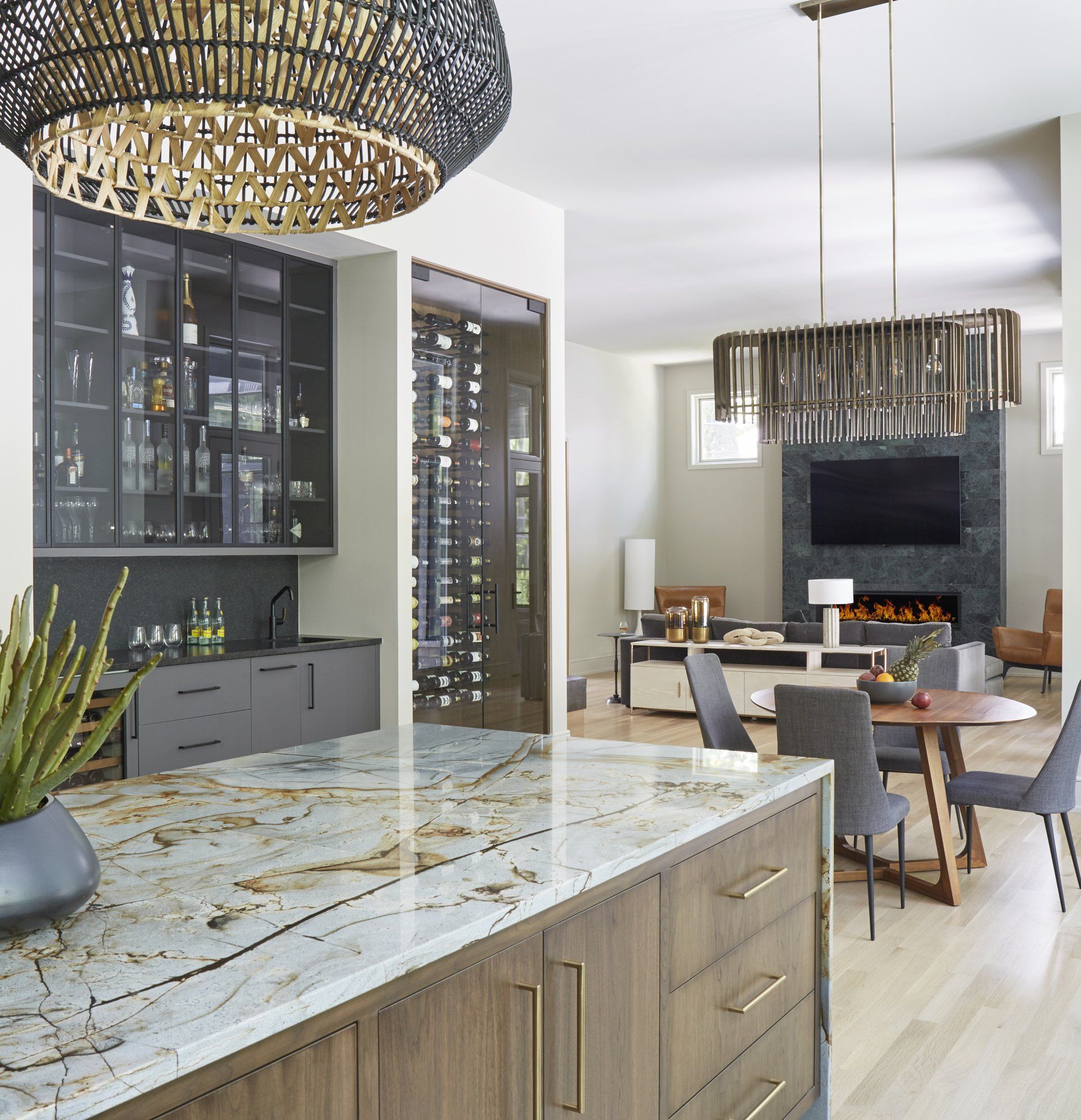 A kitchen with a marble counter top and wooden cabinets