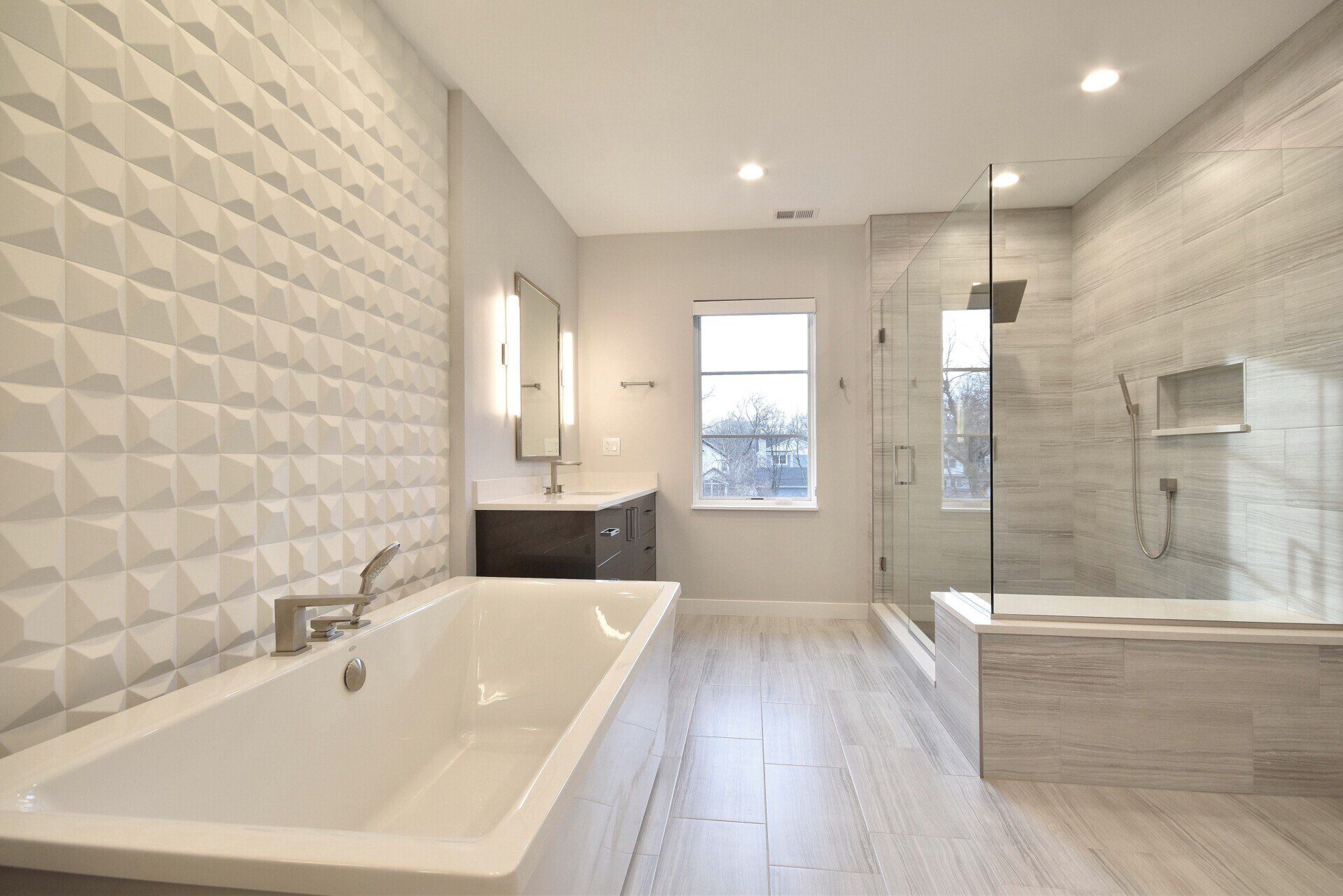 A bathroom with a bathtub and a walk in shower.