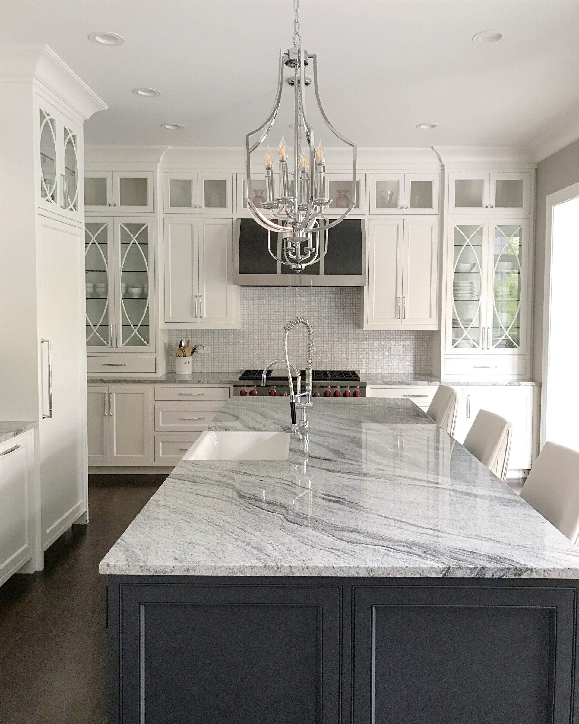 A kitchen with white cabinets and a granite counter top