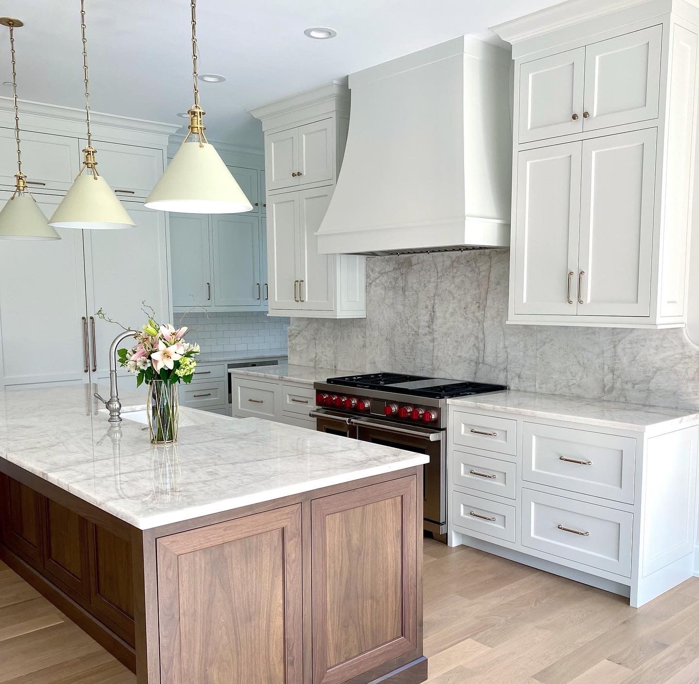 A kitchen with white cabinets and a large island