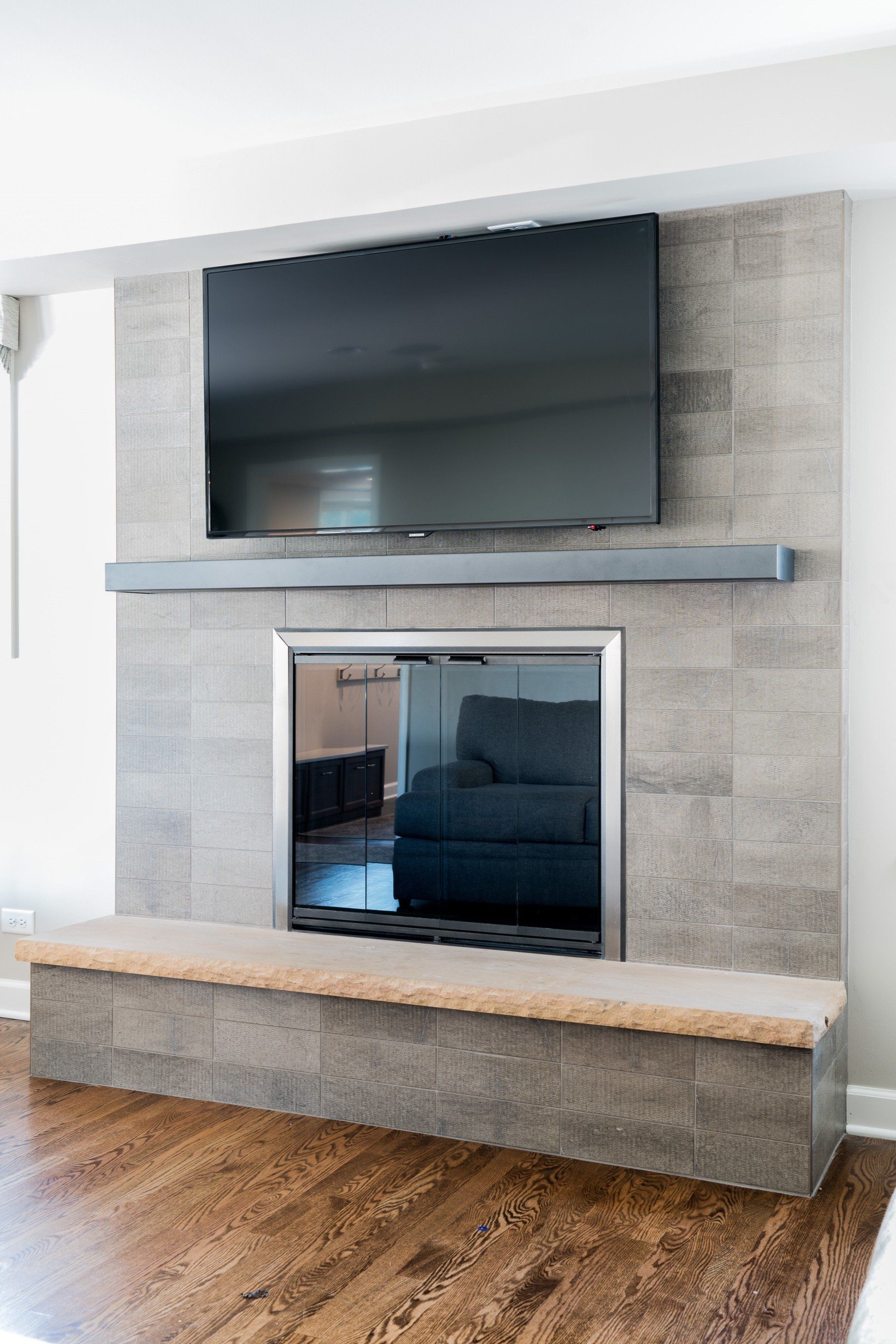 A living room with a fireplace and a flat screen tv.