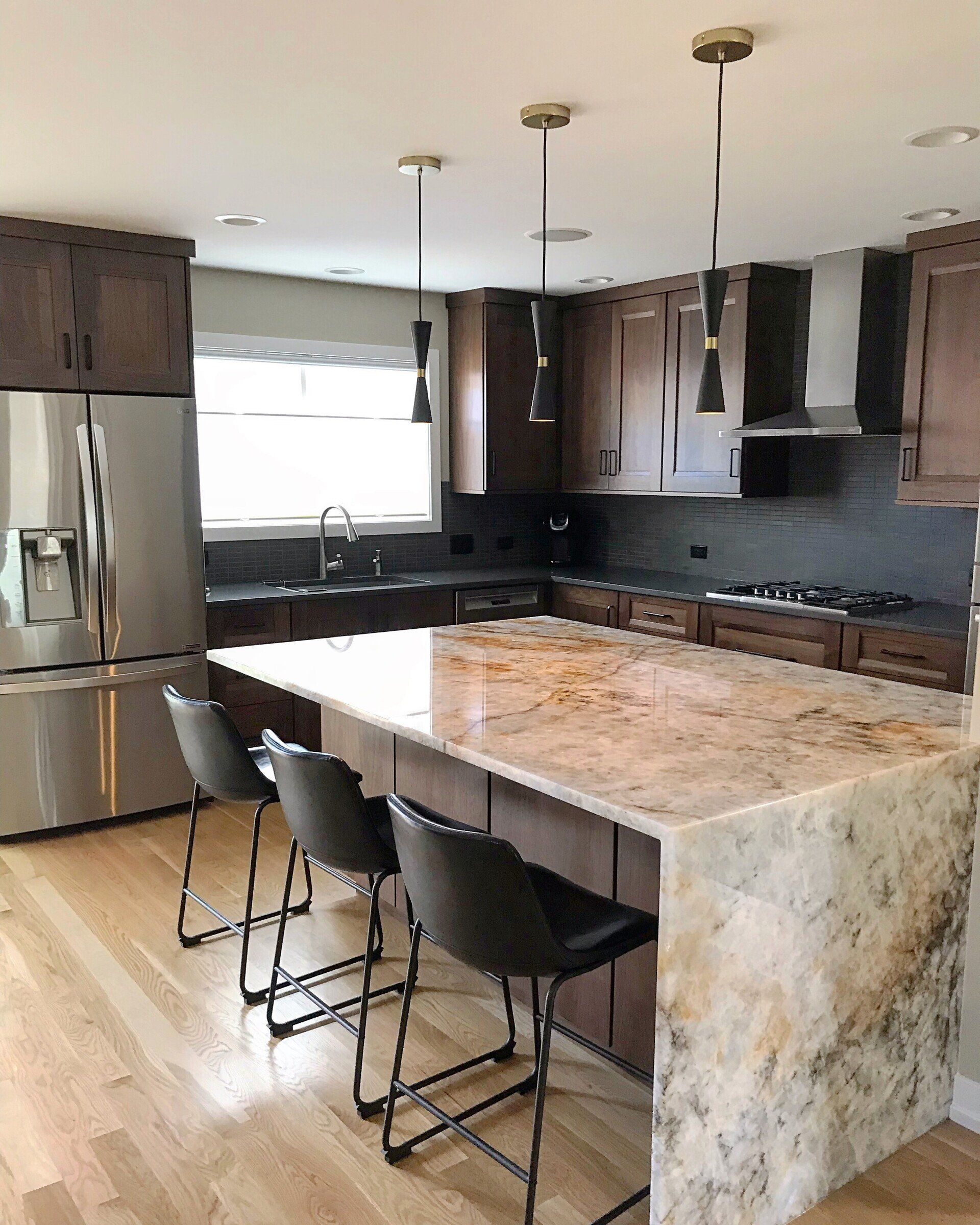 A kitchen with a large island and stools