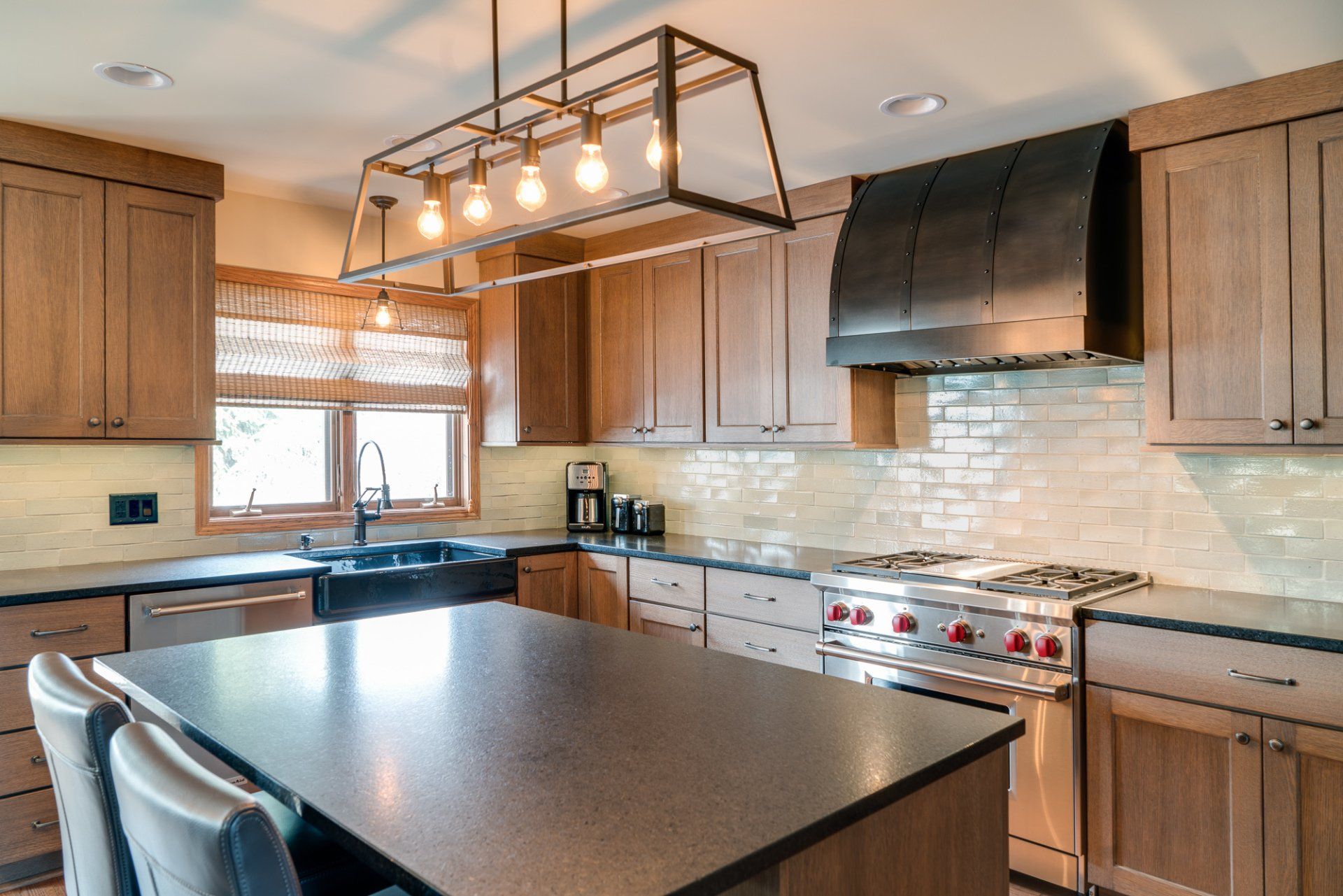 A kitchen with wooden cabinets , granite counter tops , stainless steel appliances and a large island.
